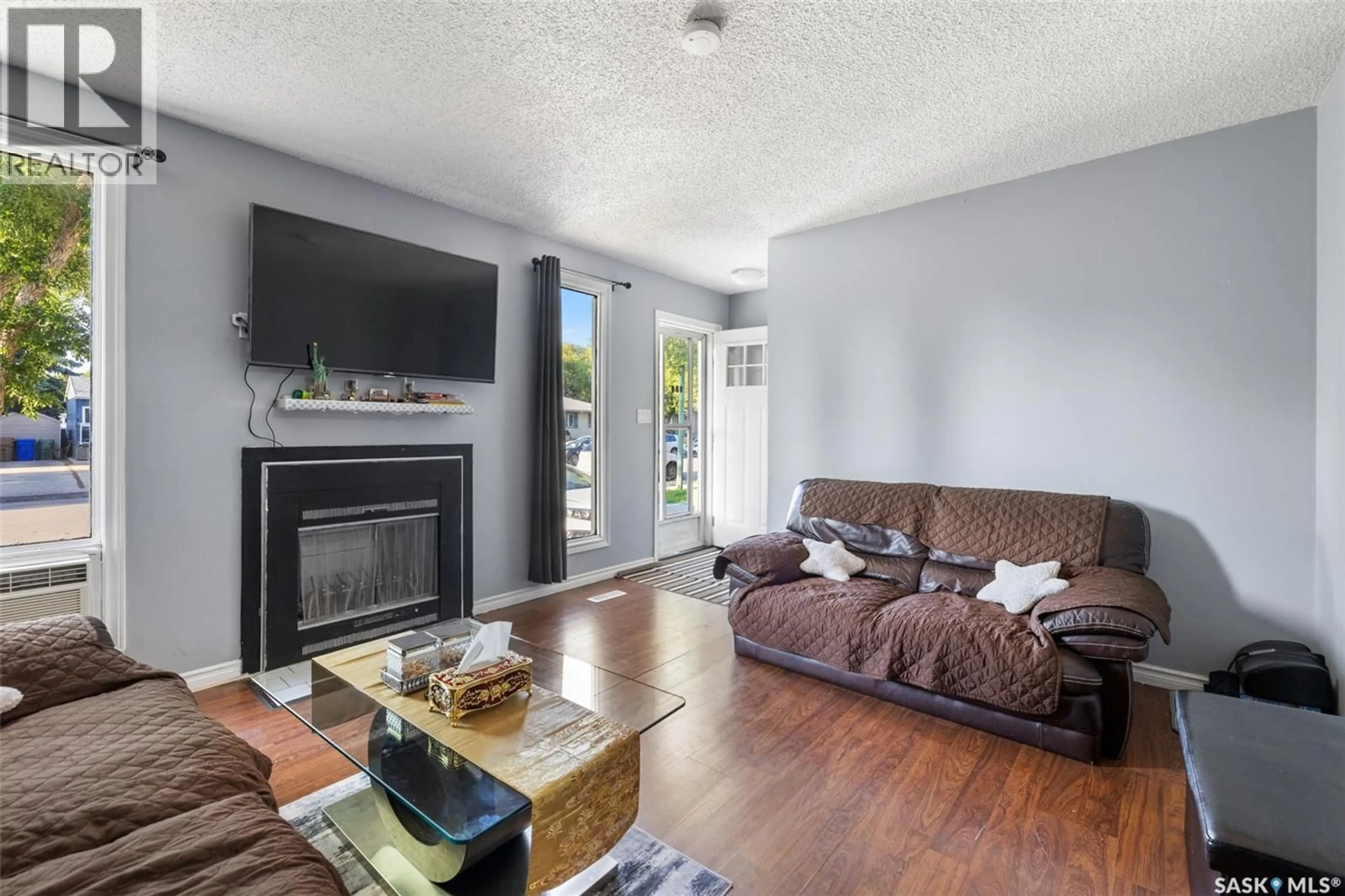 Living room with furniture, wood/laminate floor for 139 THOMSON AVENUE, Regina Saskatchewan S4N5L2