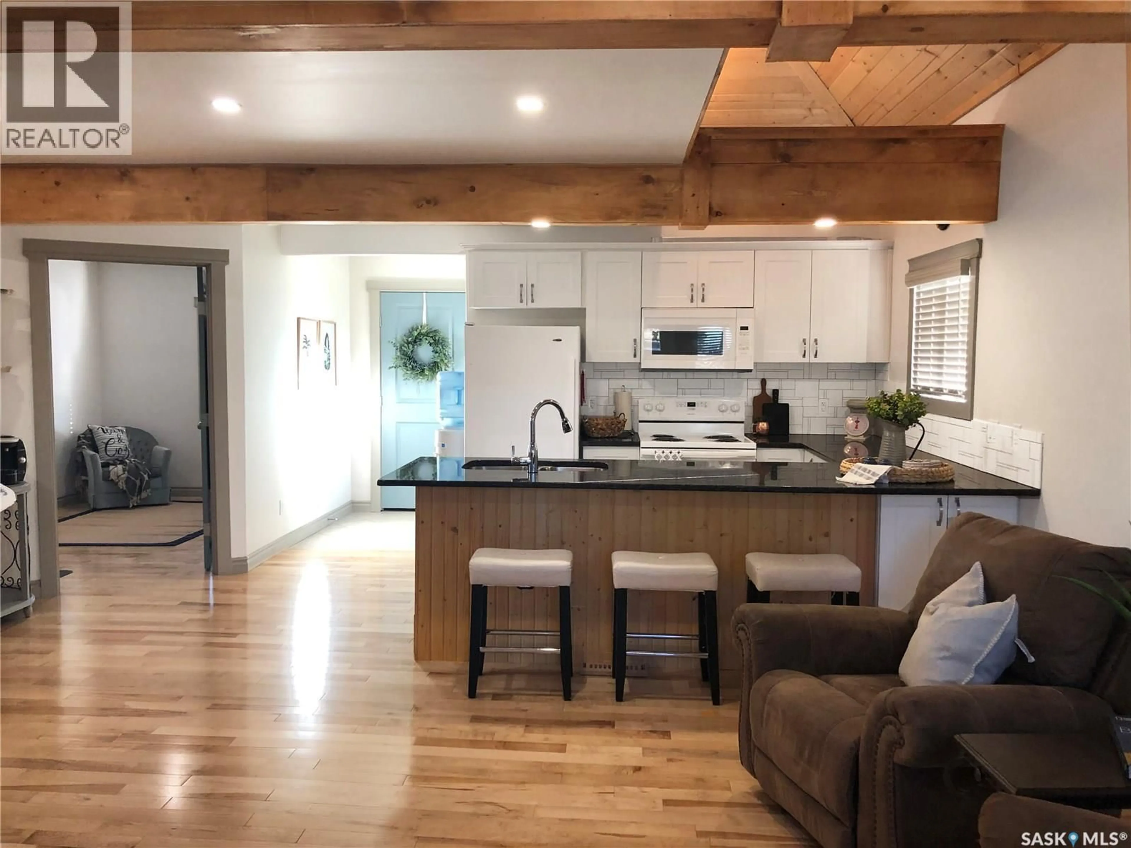 Open concept kitchen, wood/laminate floor for 707 RAILWAY STREET, Swift Current Saskatchewan S9H1E1