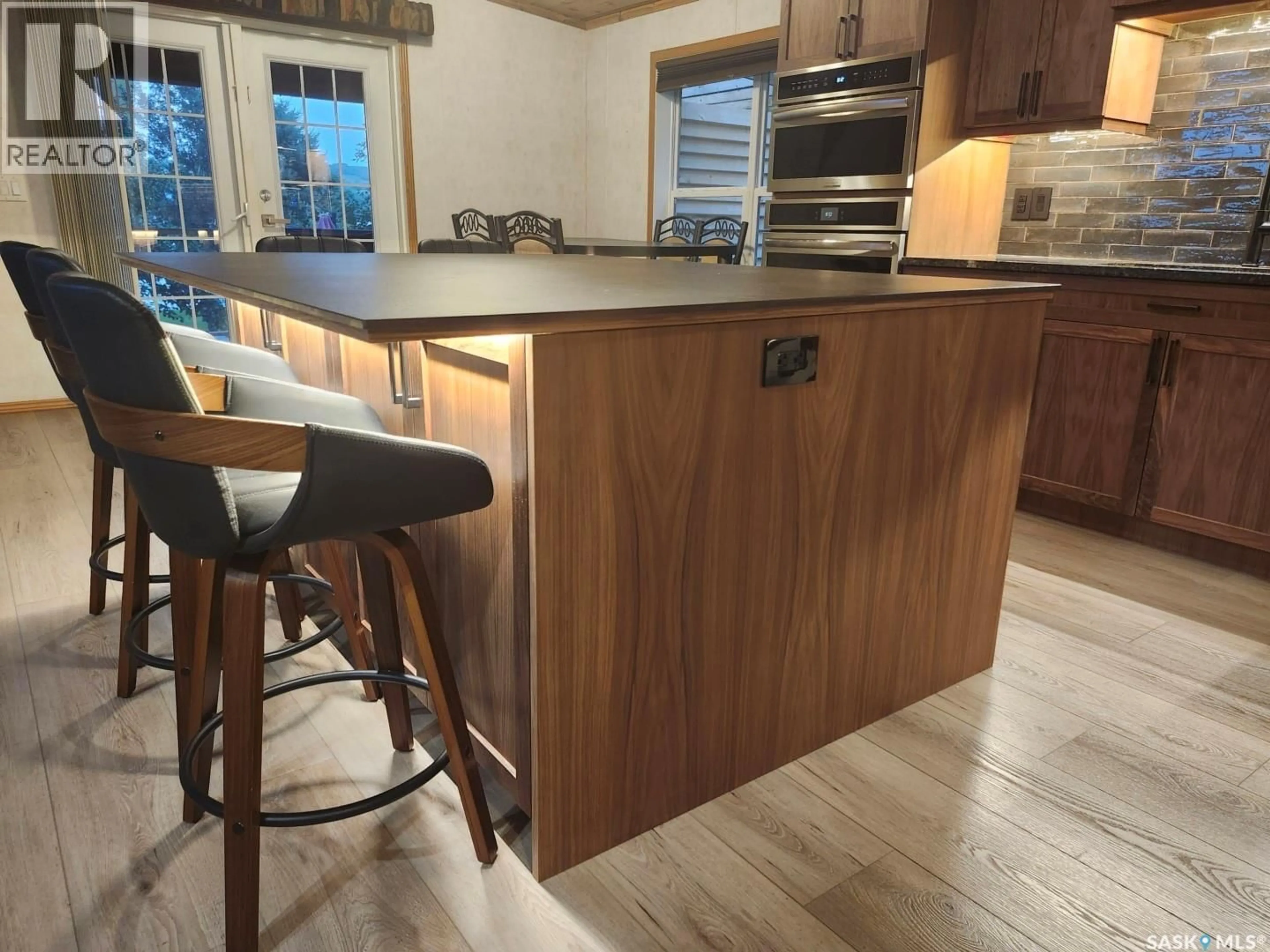 Open concept kitchen, wood/laminate floor for 309-310 DANIEL DRIVE, Buffalo Pound Lake Saskatchewan S0G0H0