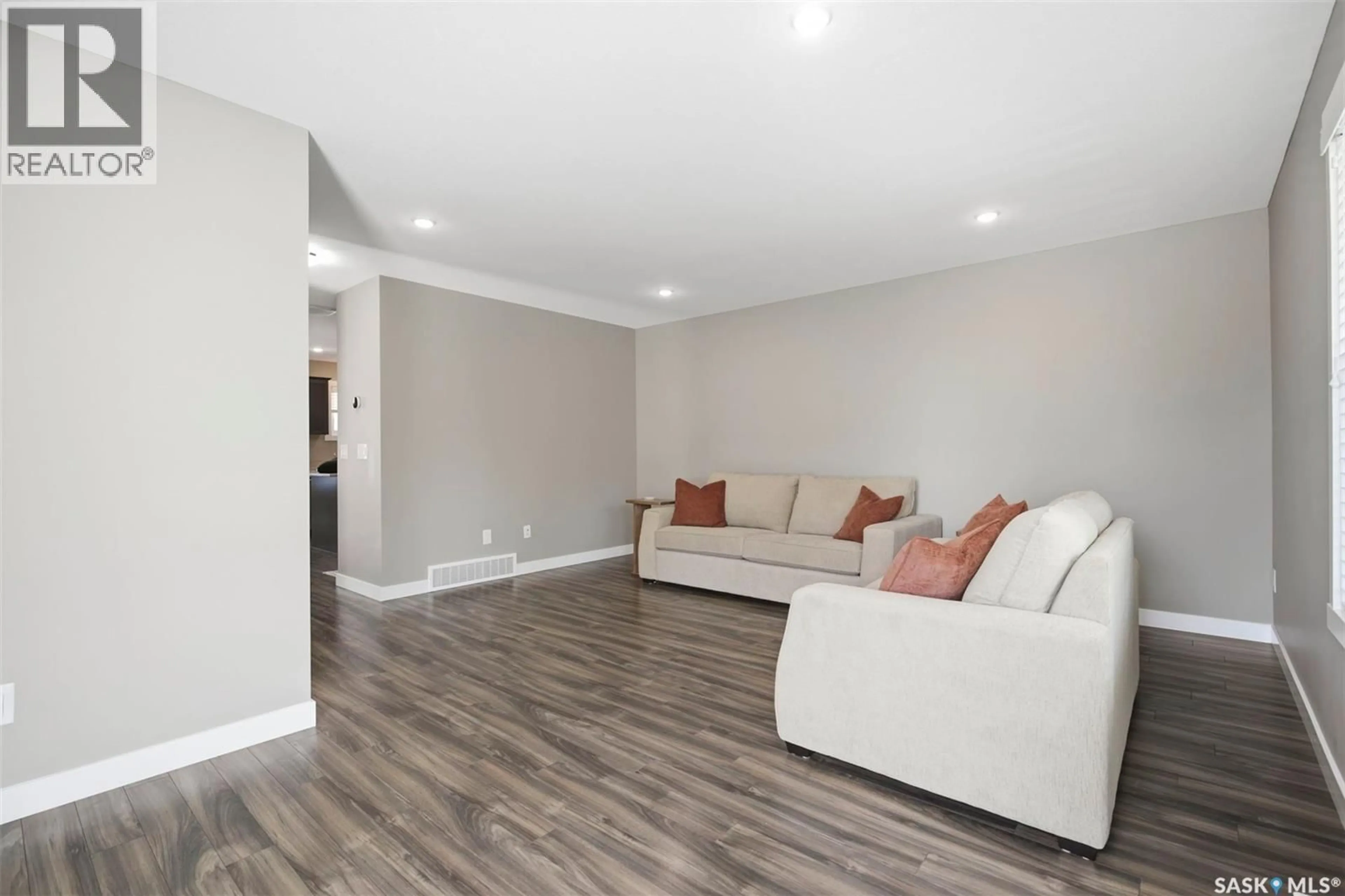 Living room with furniture, wood/laminate floor for 231 1220 PRINGLE WAY, Saskatoon Saskatchewan S7T1C9