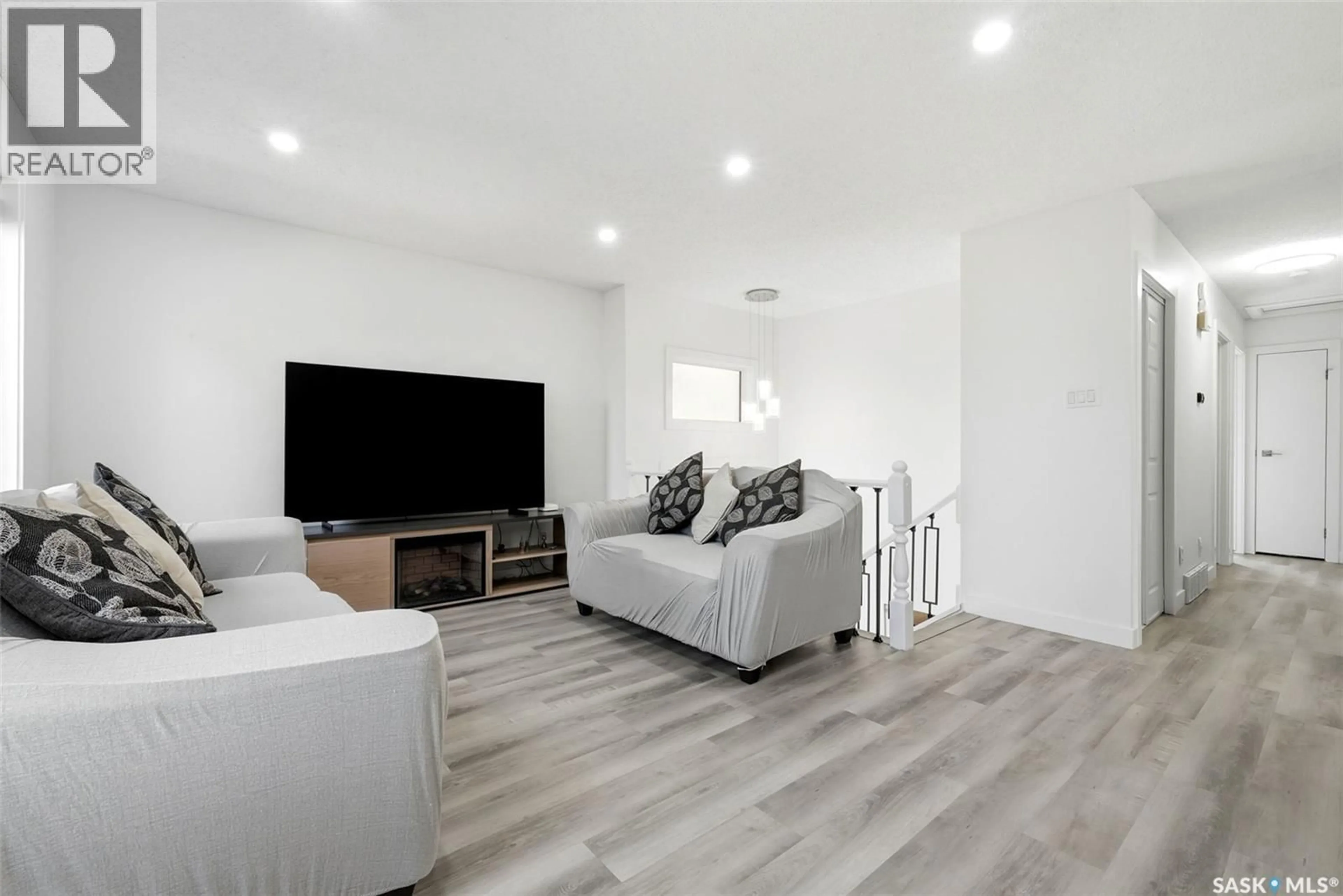 Living room with furniture, wood/laminate floor for 2715 CORBETT ROAD, Regina Saskatchewan S4R8J1