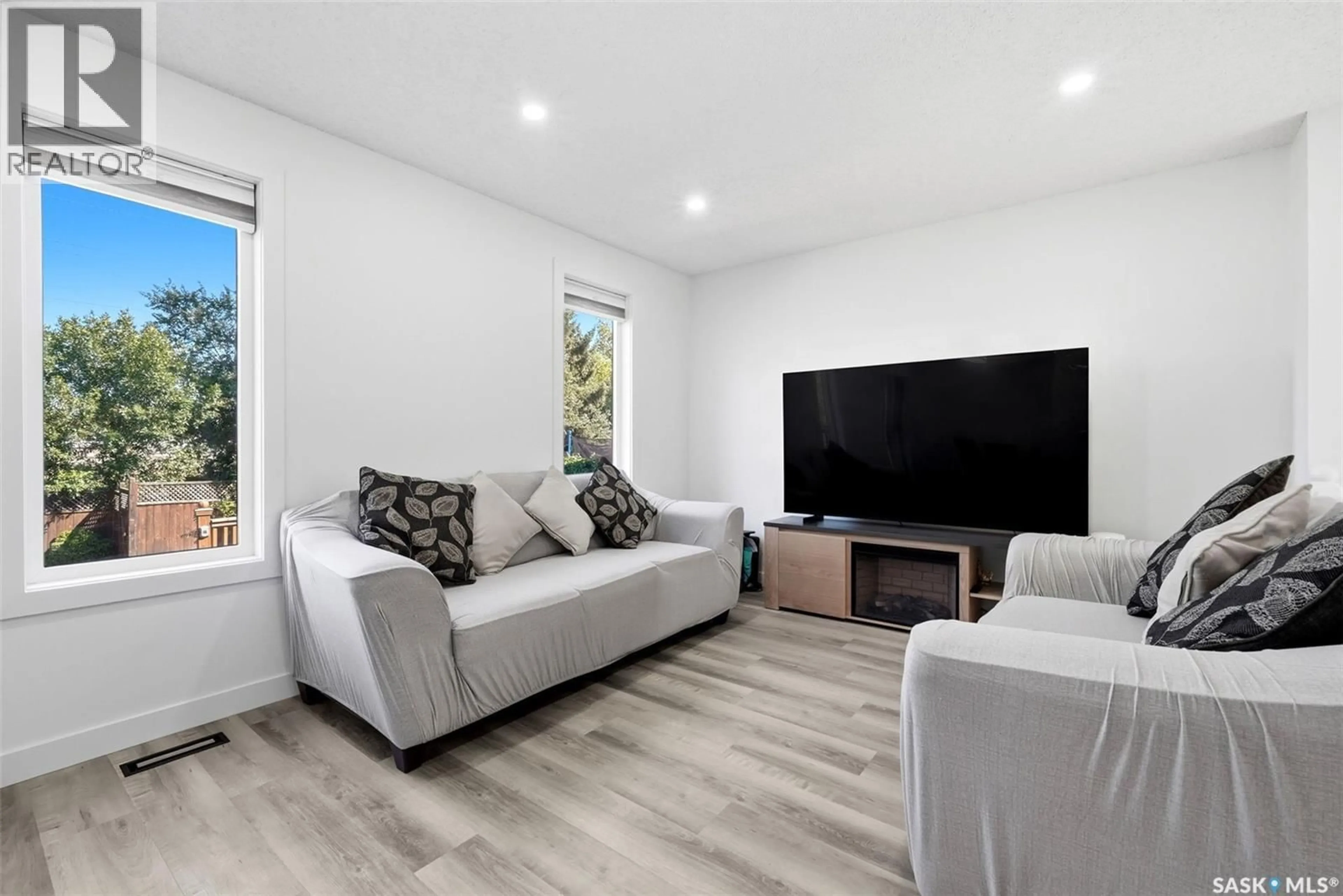 Living room with furniture, wood/laminate floor for 2715 CORBETT ROAD, Regina Saskatchewan S4R8J1