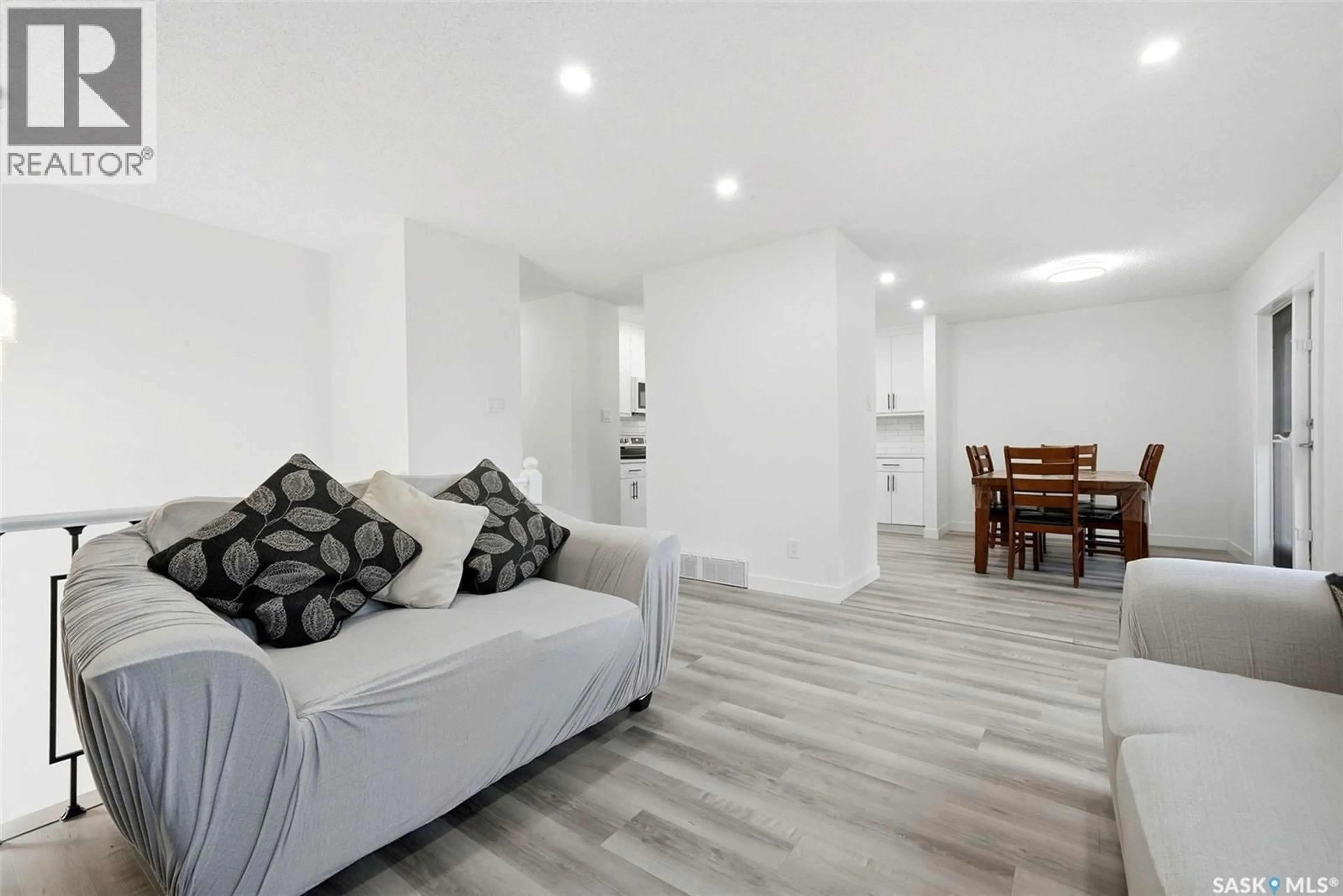 Living room with furniture, wood/laminate floor for 2715 CORBETT ROAD, Regina Saskatchewan S4R8J1