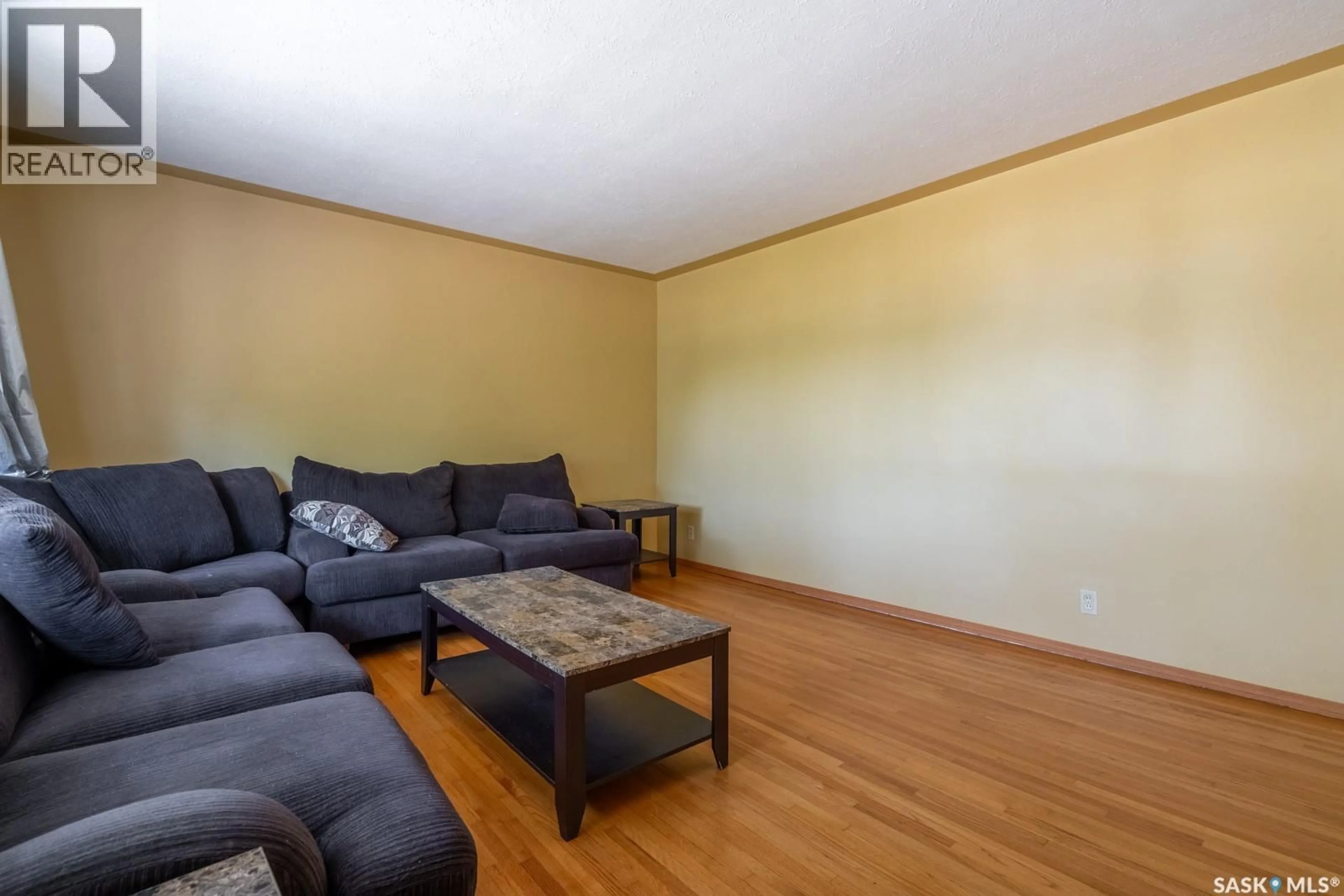 Living room with furniture, wood/laminate floor for 237 ORCHARD CRESCENT, Regina Saskatchewan S4S5B9