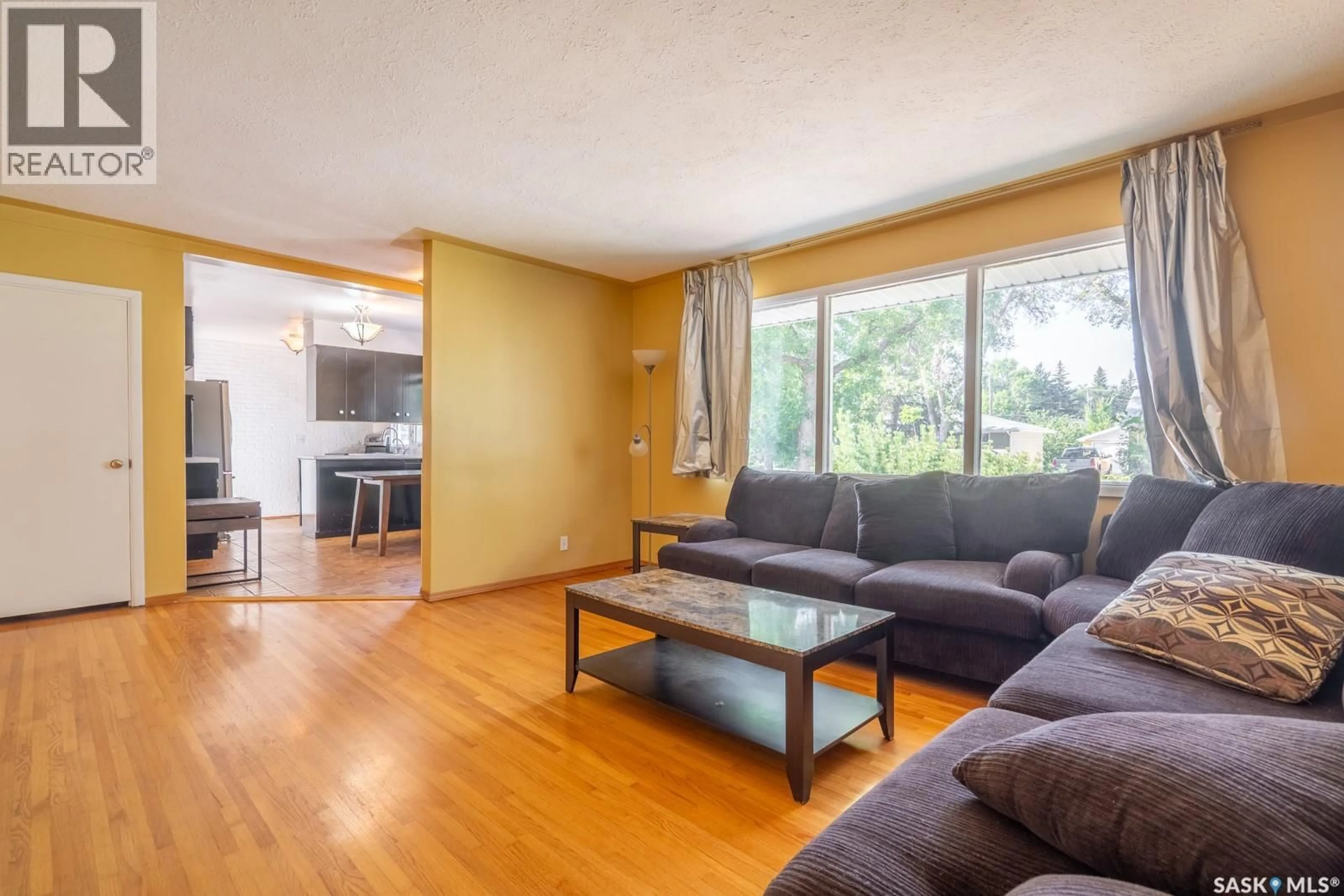 Living room with furniture, wood/laminate floor for 237 ORCHARD CRESCENT, Regina Saskatchewan S4S5B9