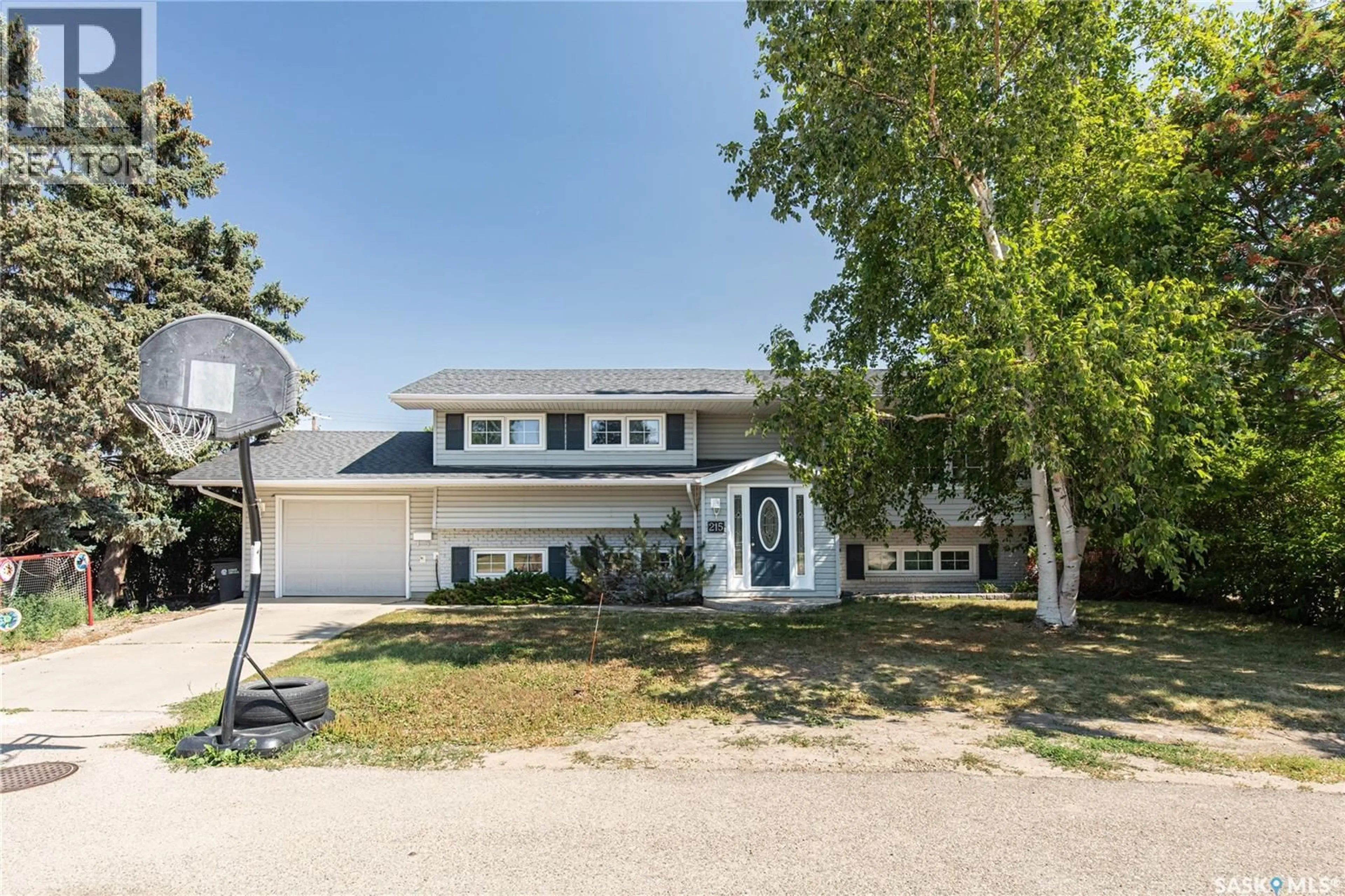 Home with vinyl exterior material, street for 215 CEDAR CRESCENT, Caronport Saskatchewan S0H0S0