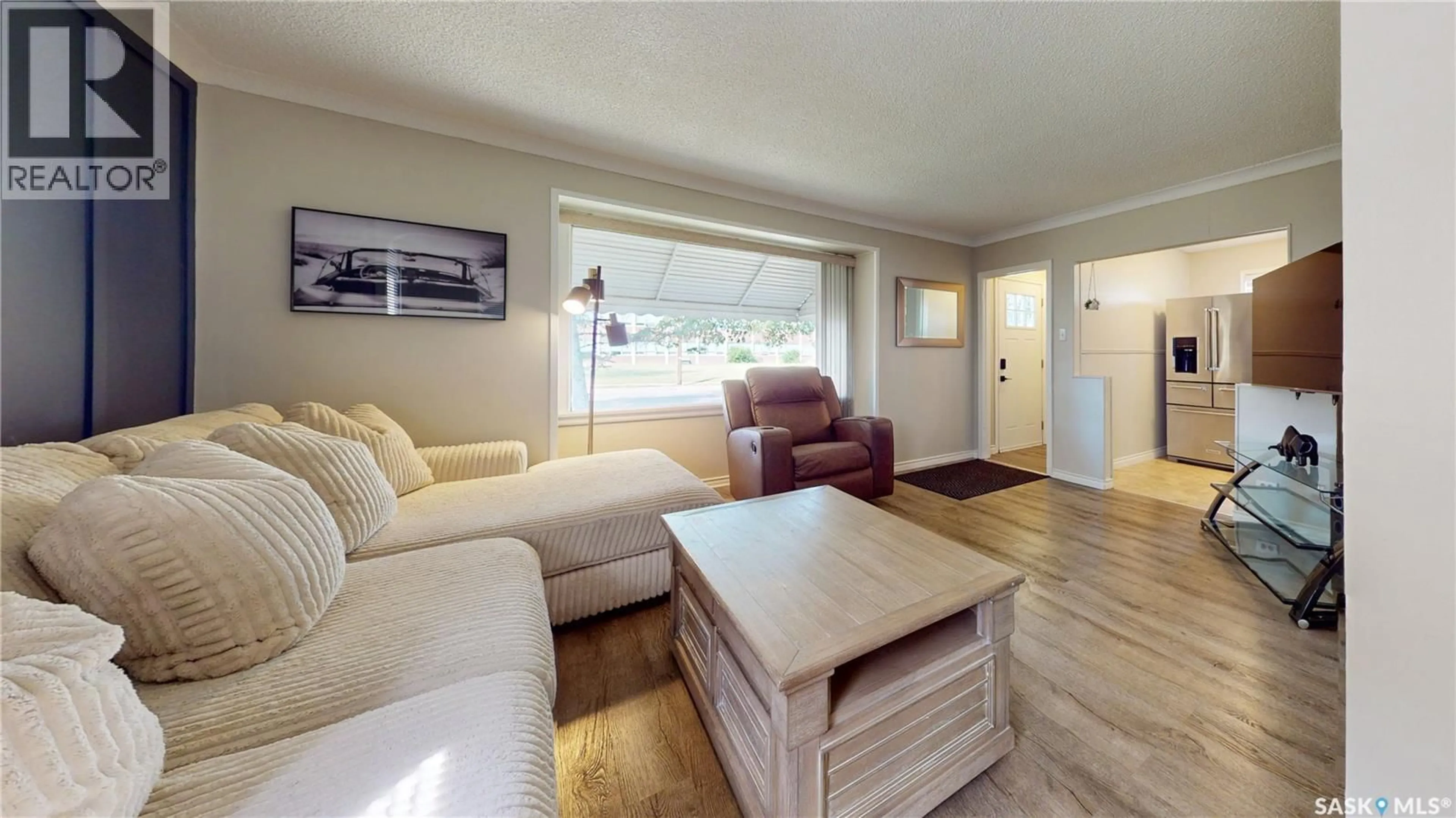 Living room with furniture, wood/laminate floor for 1073 MCINTOSH STREET, Regina Saskatchewan S4T5B8