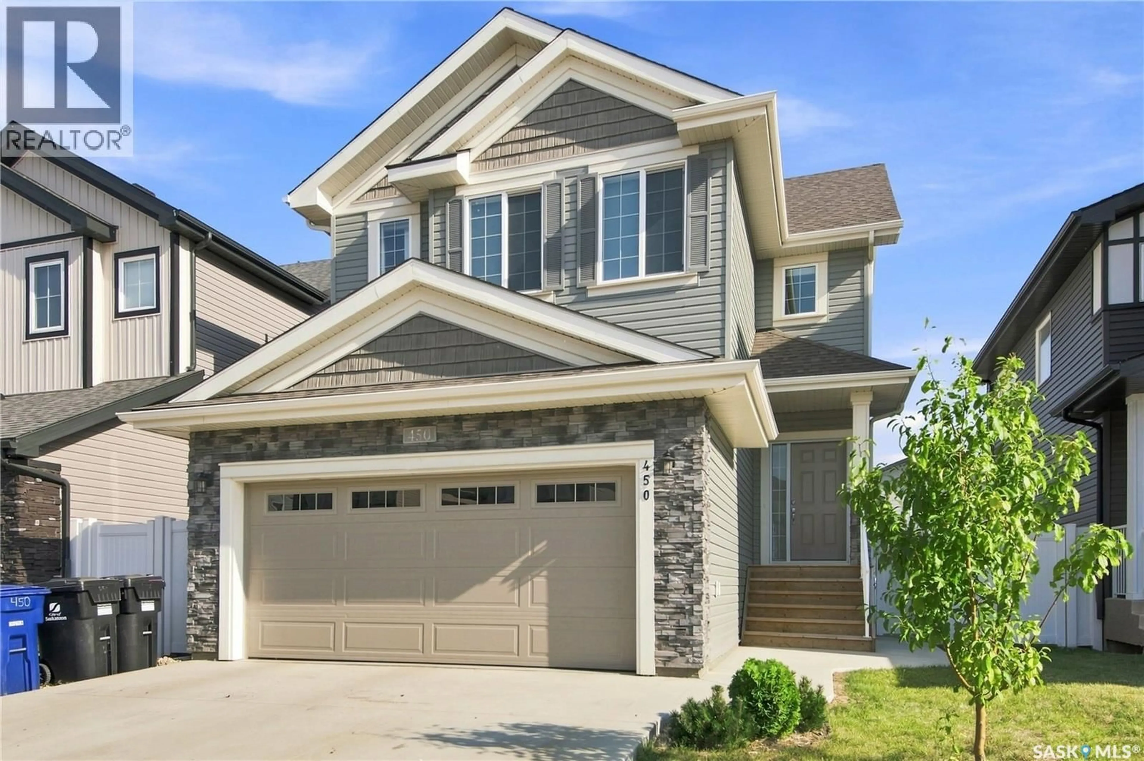 Home with vinyl exterior material, street for 450 ANISKOTAW WAY, Saskatoon Saskatchewan S7V1M3