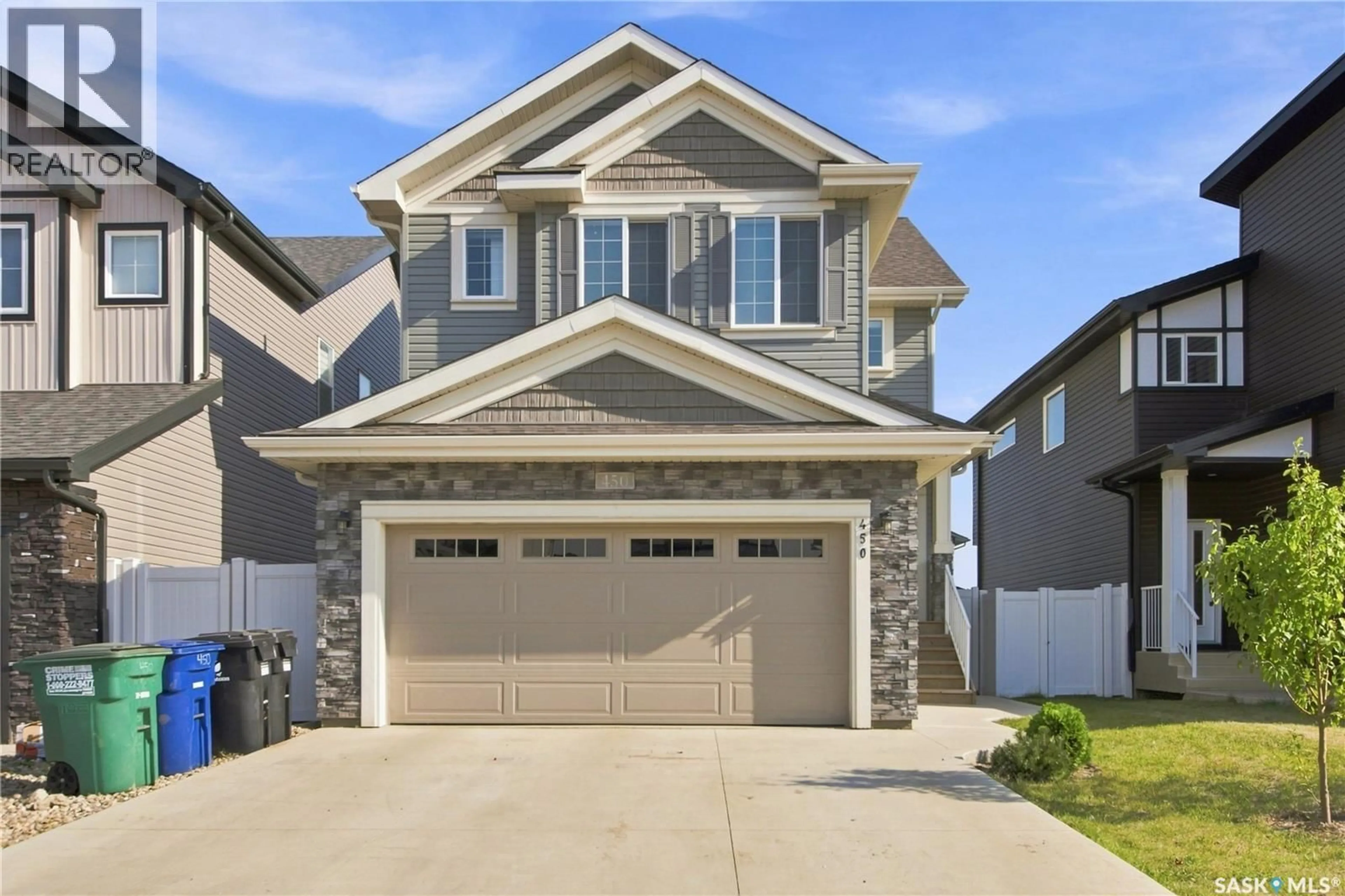 Home with vinyl exterior material, street for 450 ANISKOTAW WAY, Saskatoon Saskatchewan S7V1M3