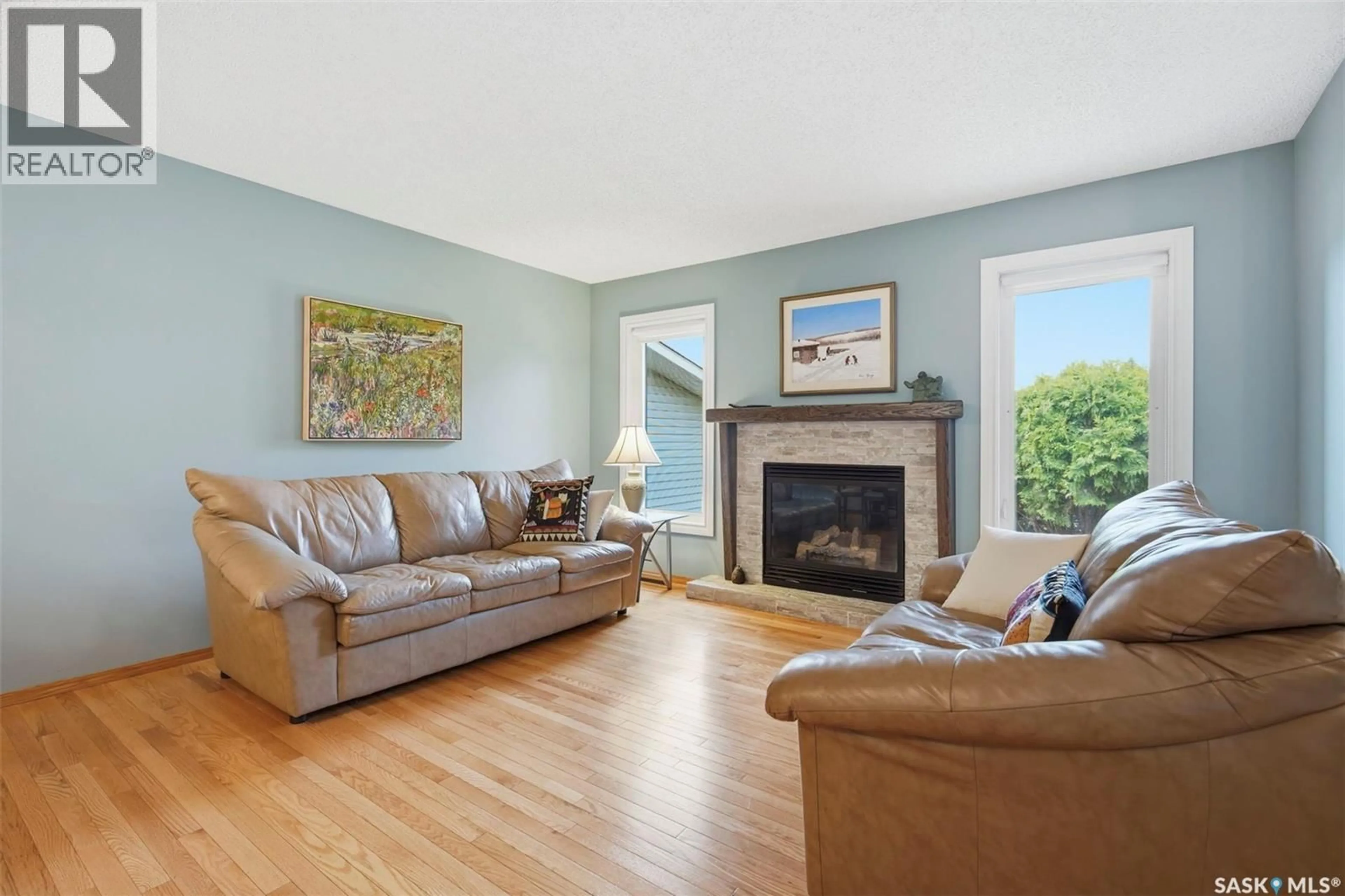 Living room with furniture, wood/laminate floor for 351 MARCOTTE CRESCENT, Saskatoon Saskatchewan S7K7N9