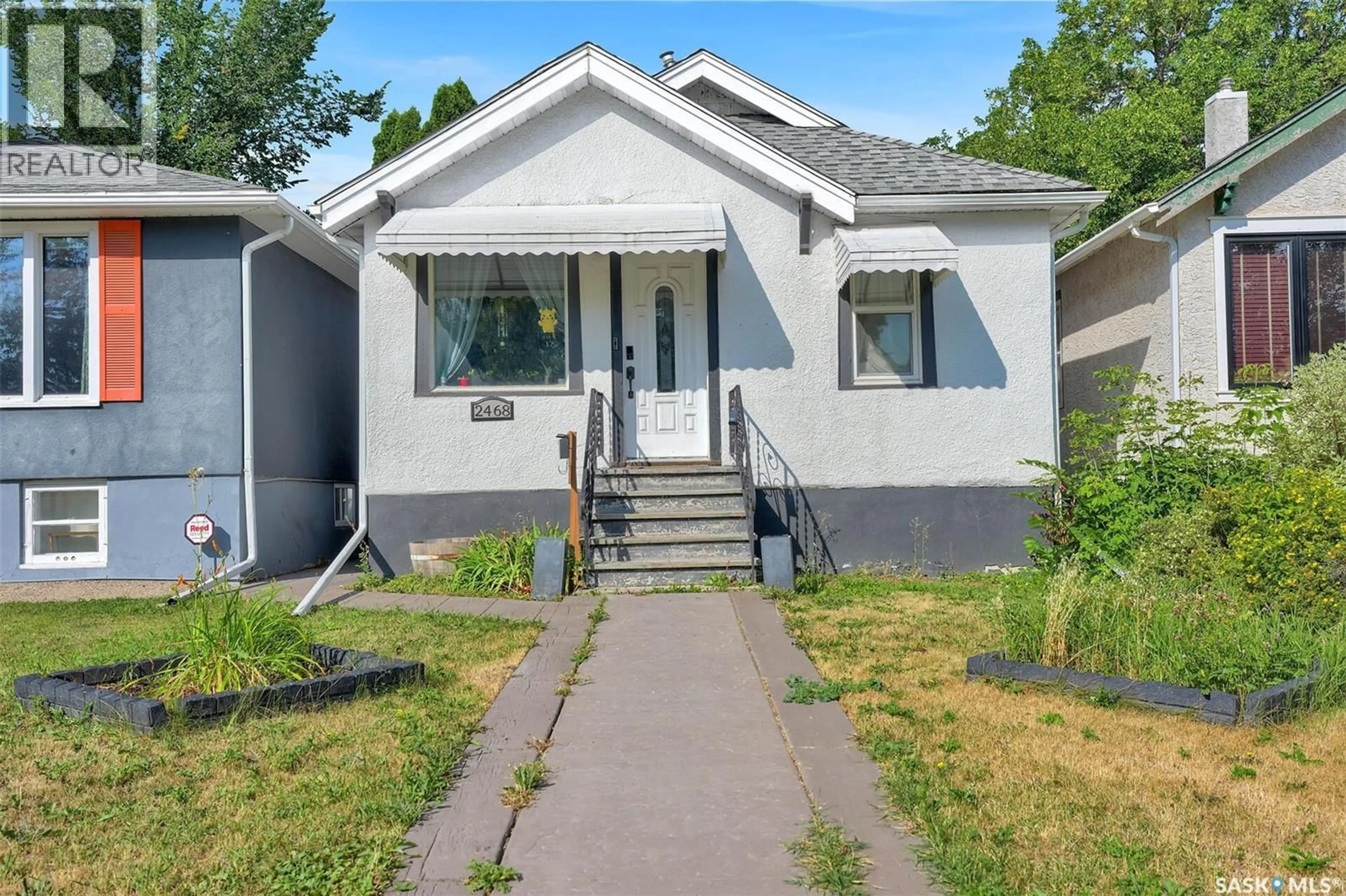 Home with vinyl exterior material, street for 2468 ELLIOTT STREET, Regina Saskatchewan S4N3H3