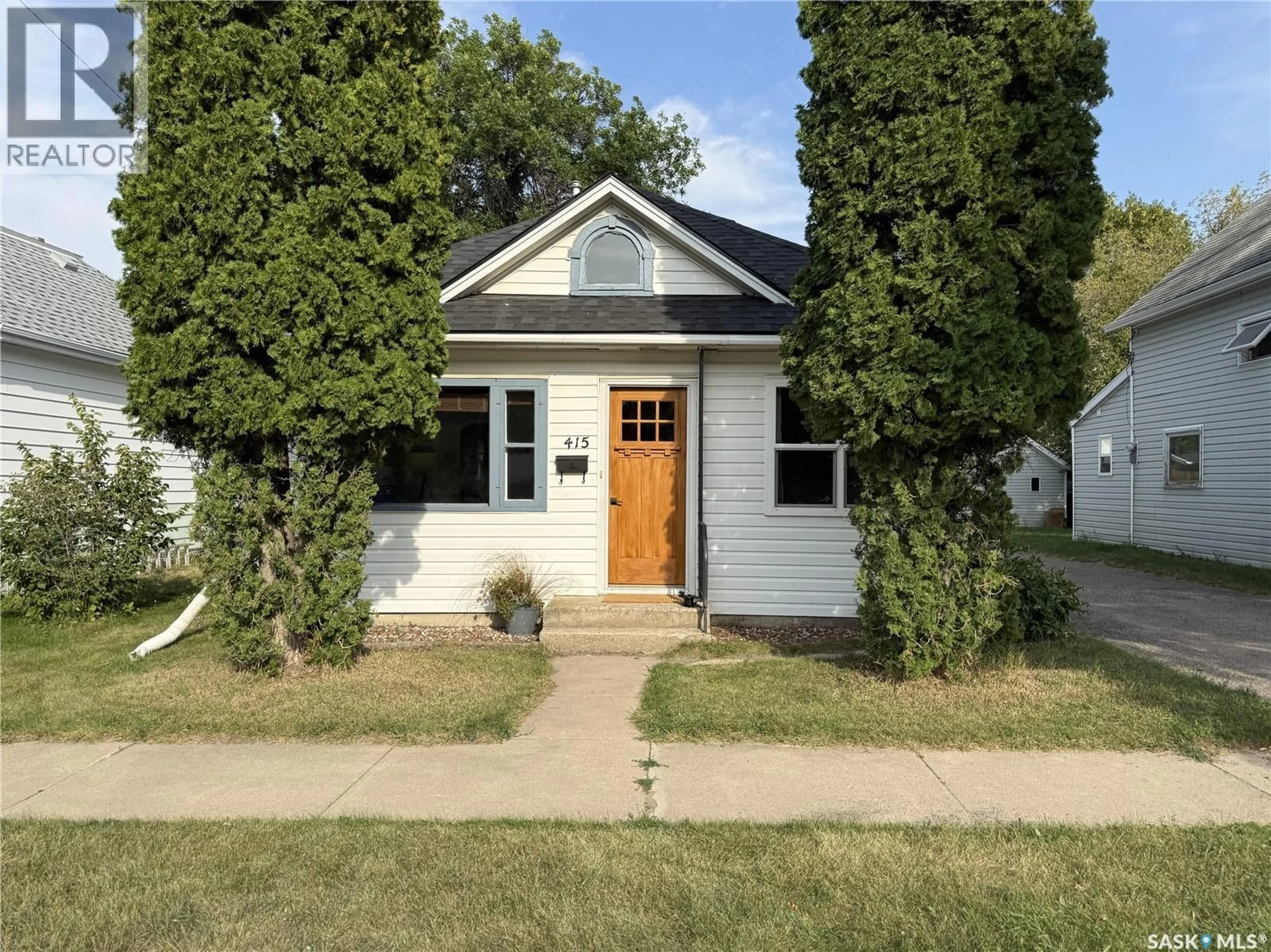Home with vinyl exterior material, street for 415 MCTAVISH STREET, Outlook Saskatchewan S0L2N0