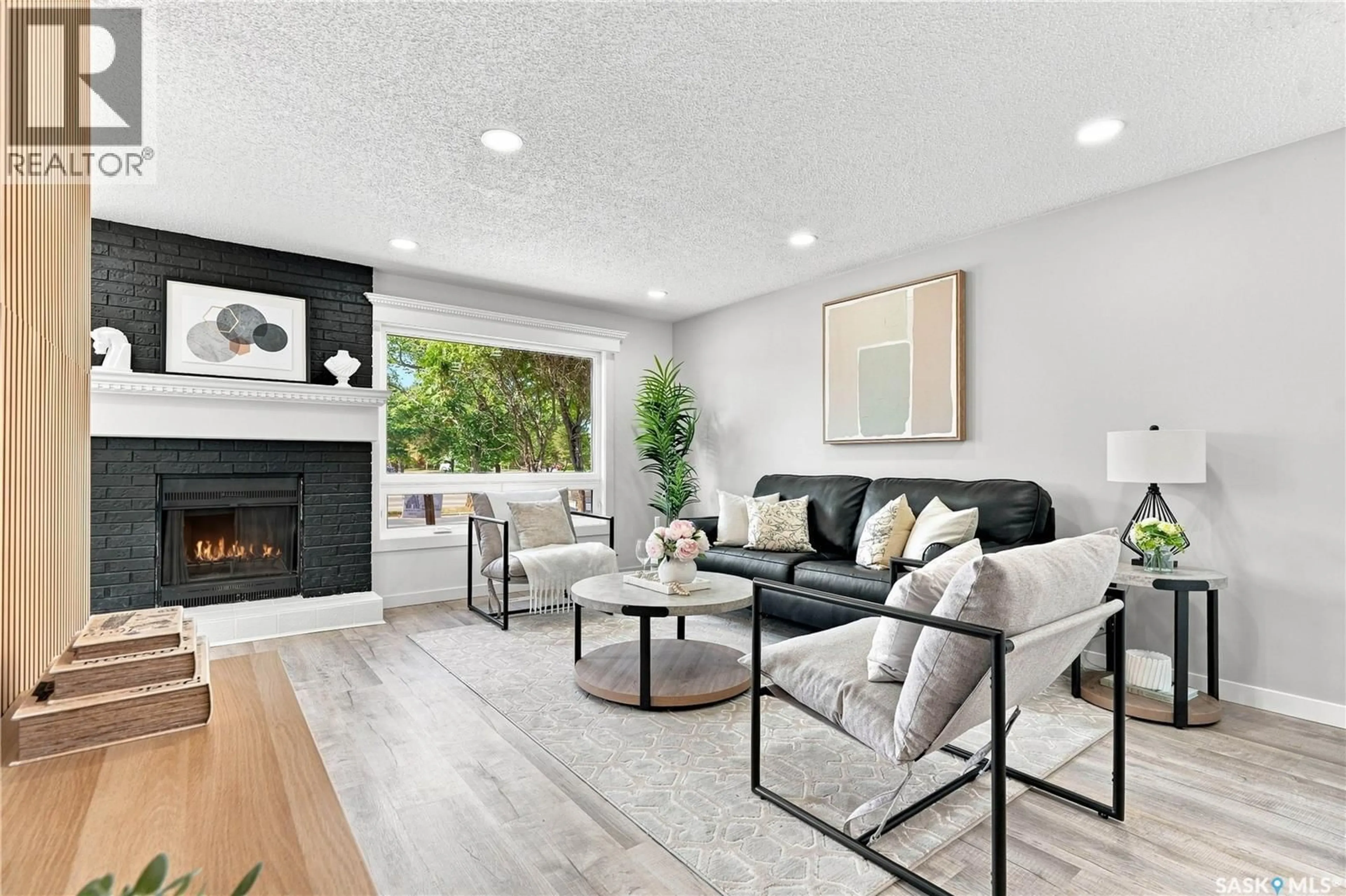 Living room with furniture, wood/laminate floor for 607 LENORE DRIVE, Saskatoon Saskatchewan S7K5G7