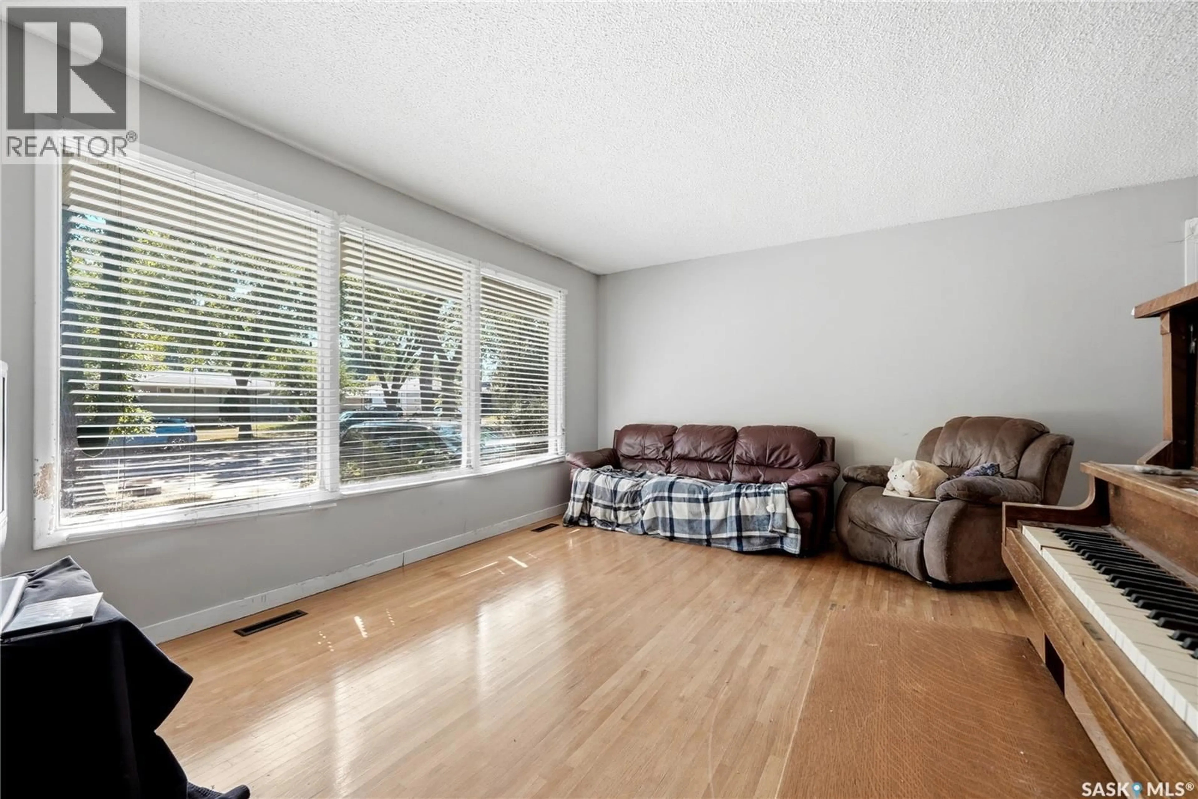 Living room with furniture, wood/laminate floor for 1722 MACPHERSON AVENUE, Regina Saskatchewan S4S4C9
