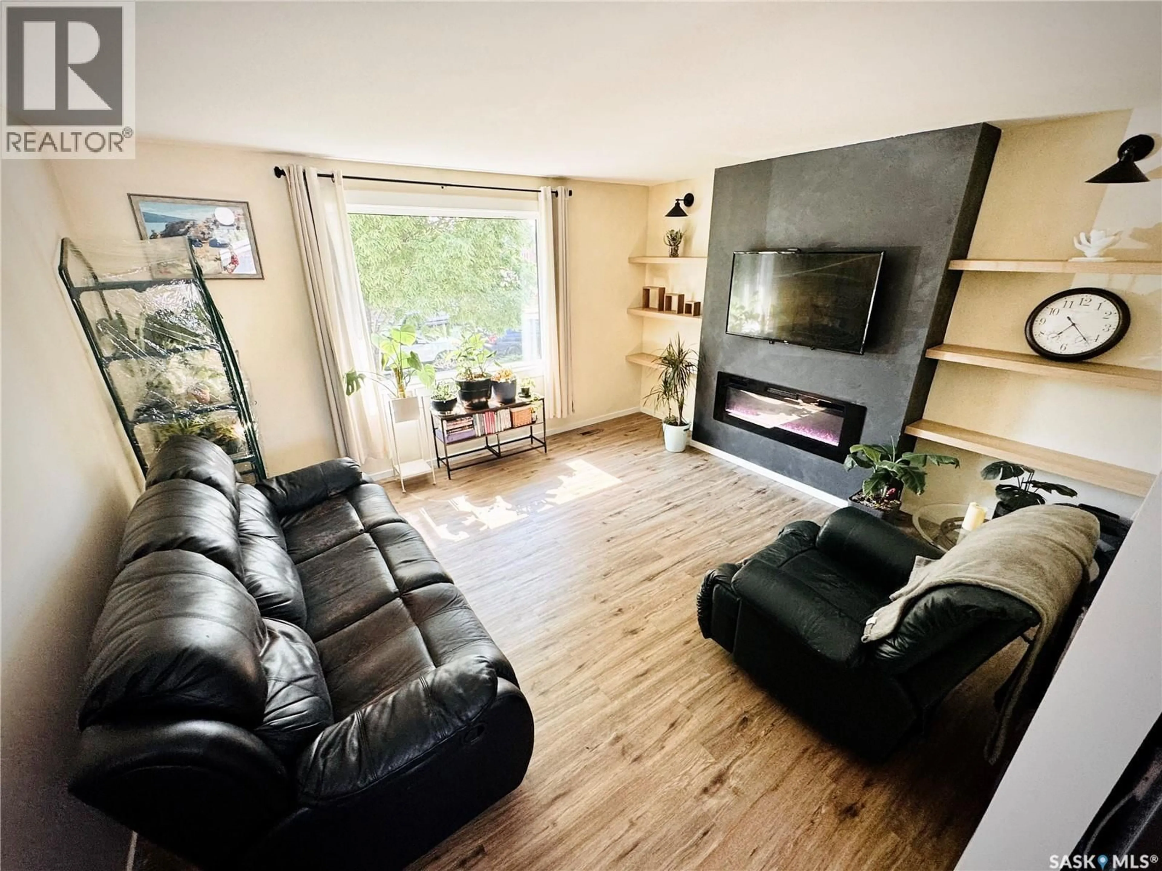 Living room with furniture, wood/laminate floor for 110 ARNASON CRESCENT, Saskatoon Saskatchewan S7H4M8