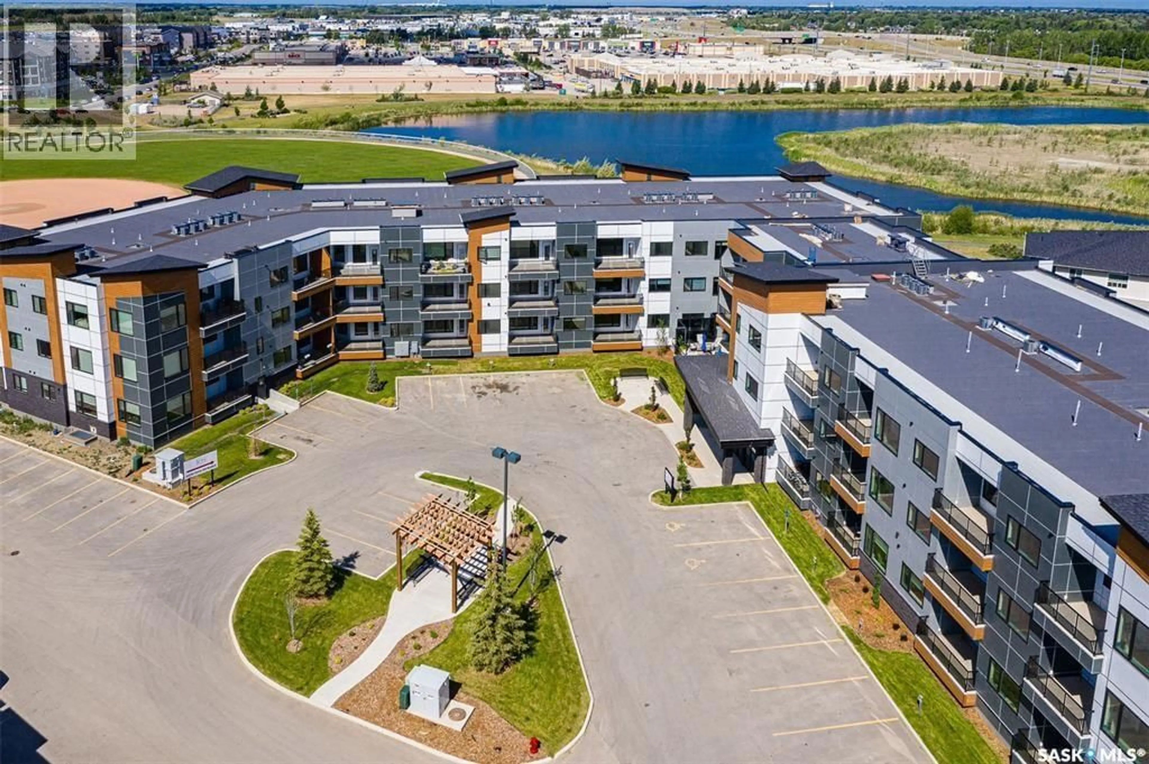 A pic from outside/outdoor area/front of a property/back of a property/a pic from drone, water/lake/river/ocean view for 105 - 313 WILLIS CRESCENT, Saskatoon Saskatchewan S7T0Z3