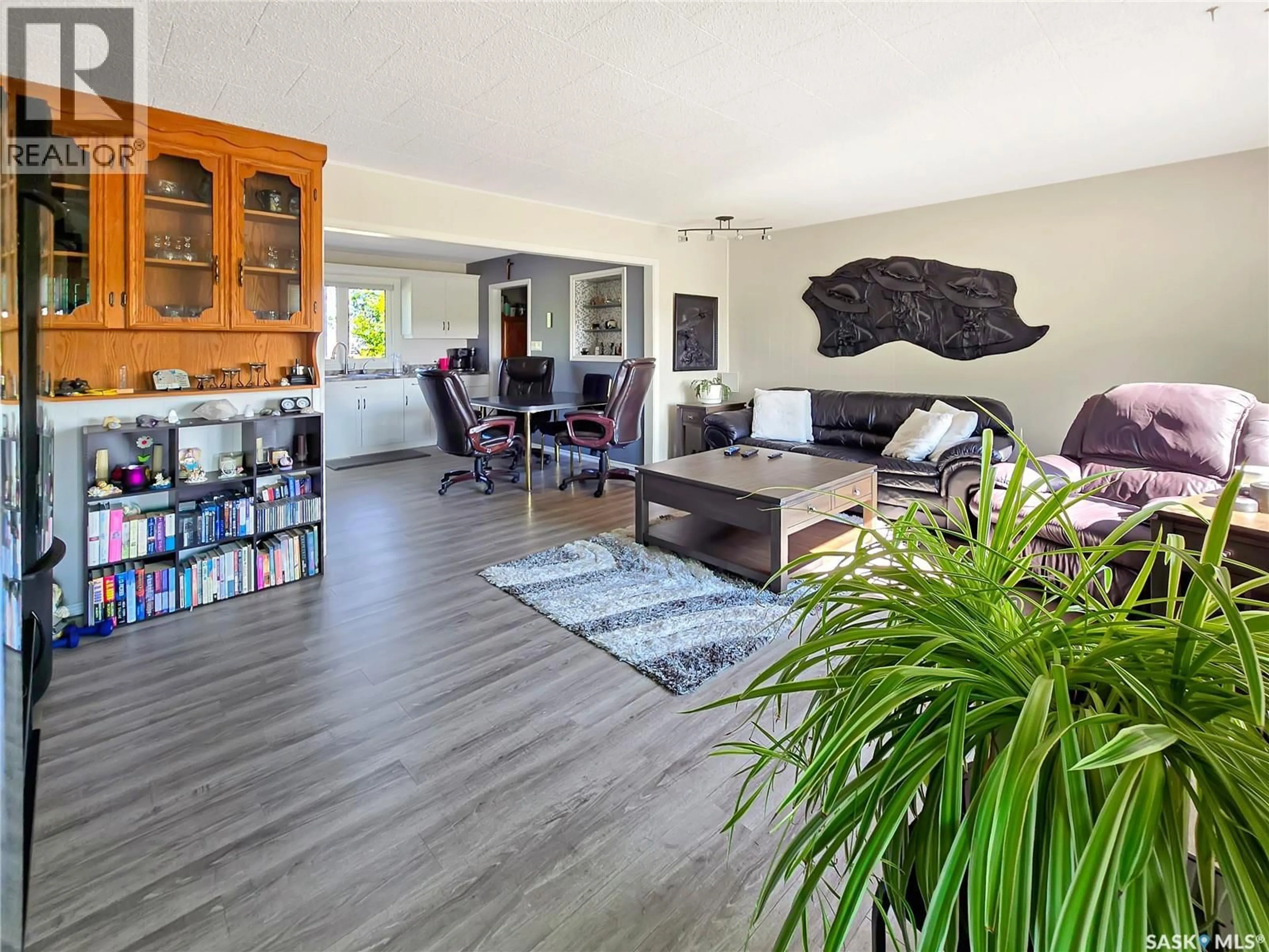 Living room with furniture, wood/laminate floor for 16 RAILWAY AVENUE, Killaly Saskatchewan S0A1X0