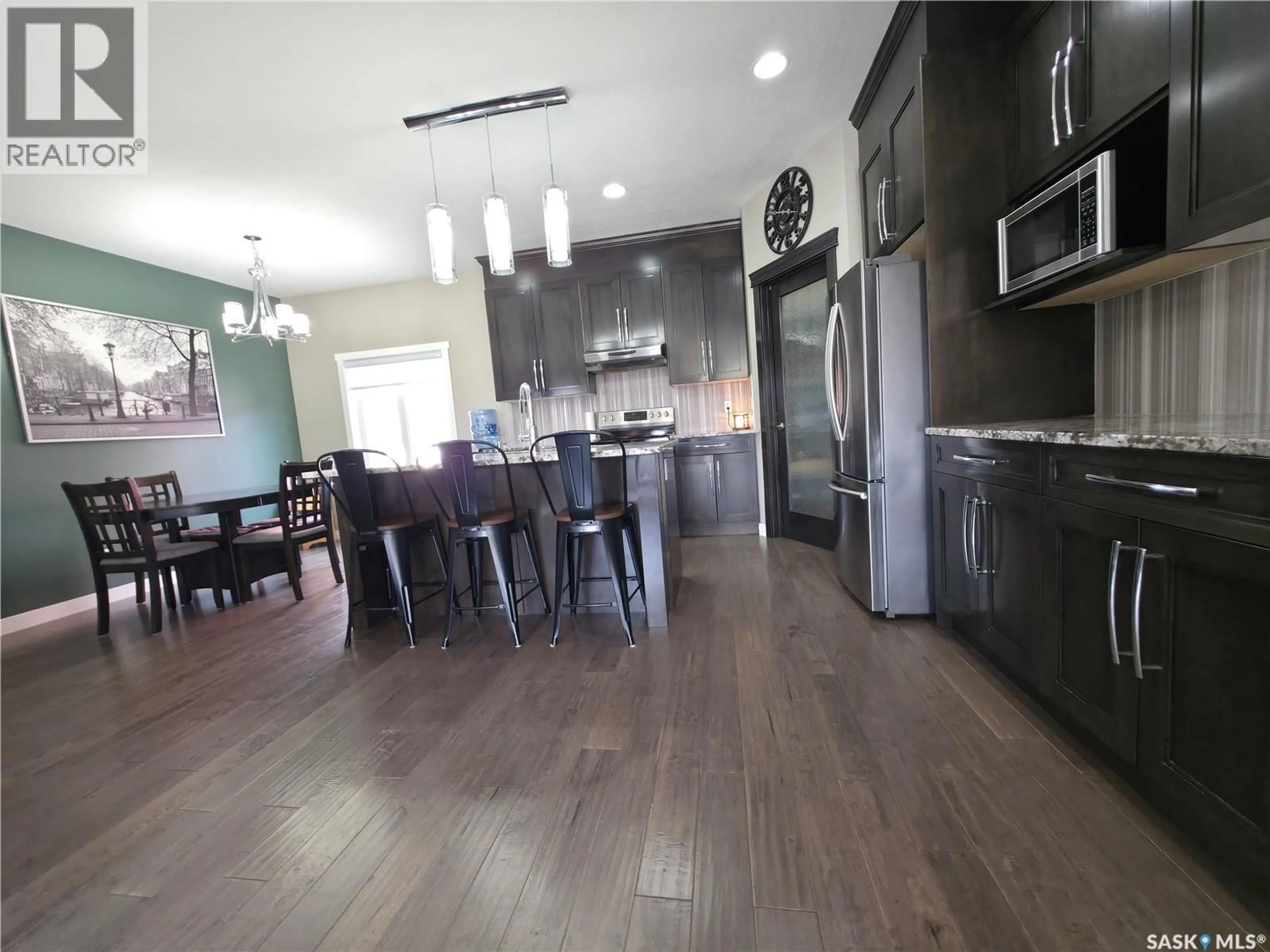 Open concept kitchen, wood/laminate floor for 201 VALLEY MEADOW COURT, Swift Current Saskatchewan S9H5N2