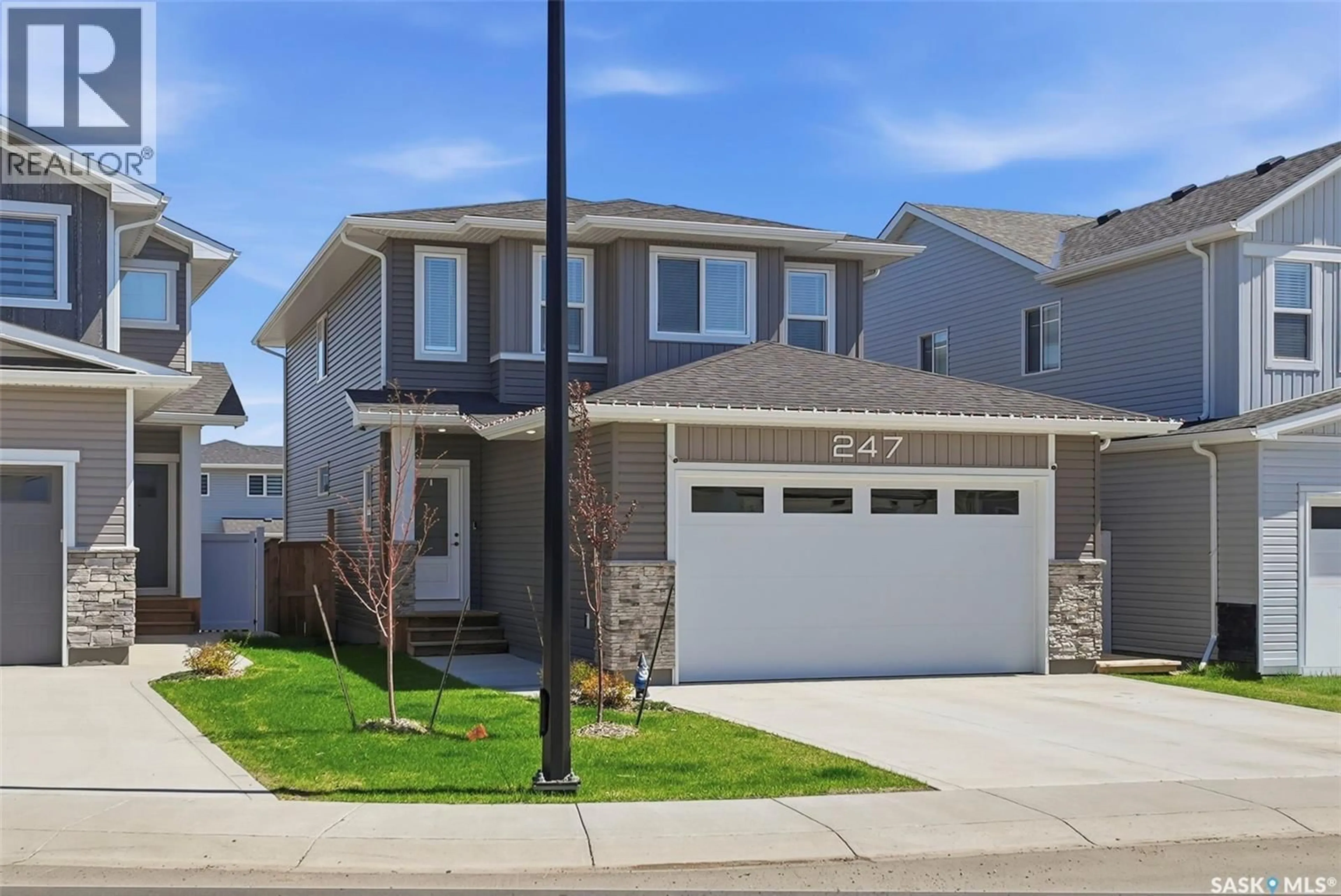 Home with vinyl exterior material, street for 247 PRASAD MANOR, Saskatoon Saskatchewan S7V1L5