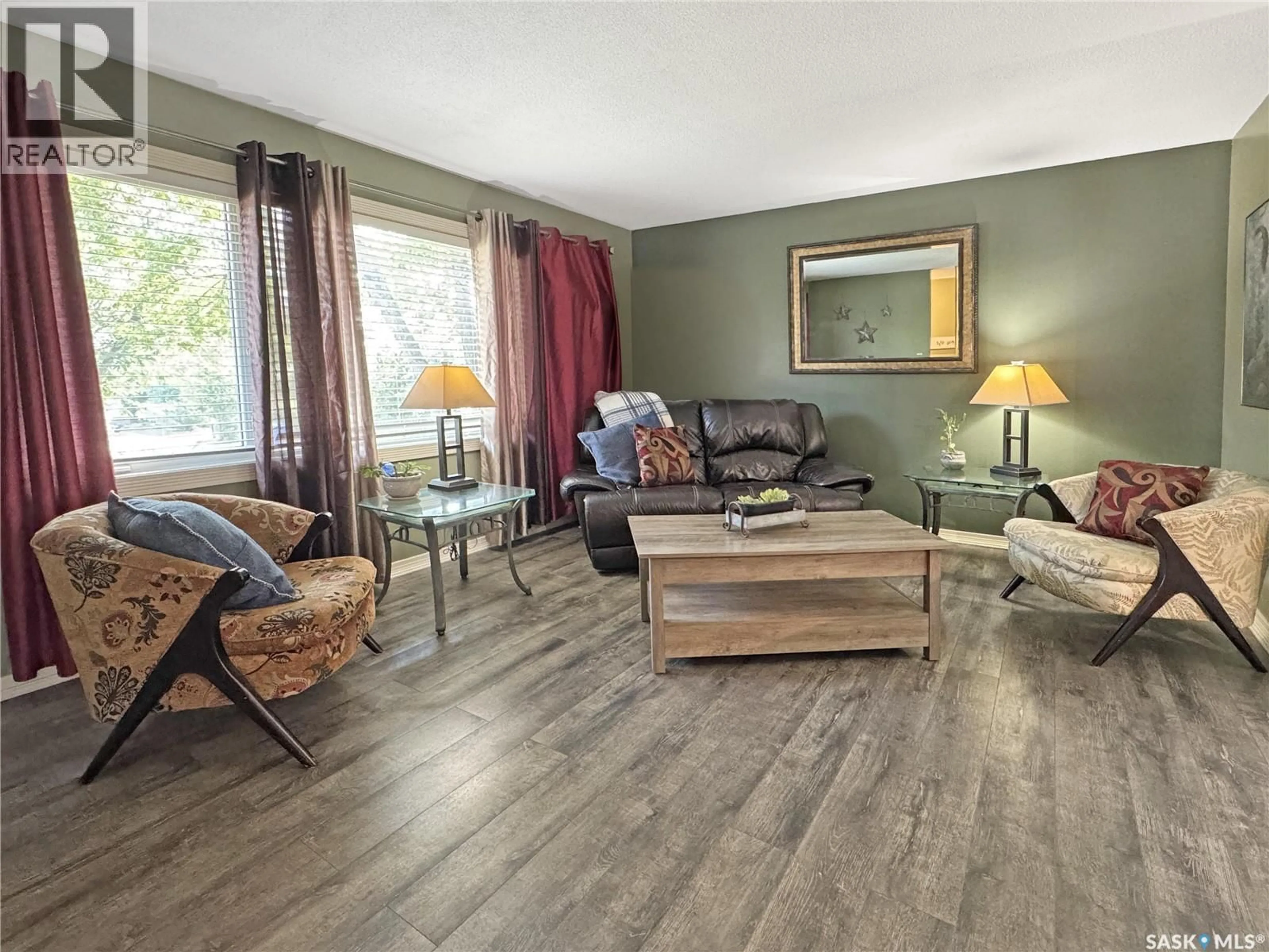 Living room with furniture, wood/laminate floor for 511 101ST STREET, North Battleford Saskatchewan S9A0Y5