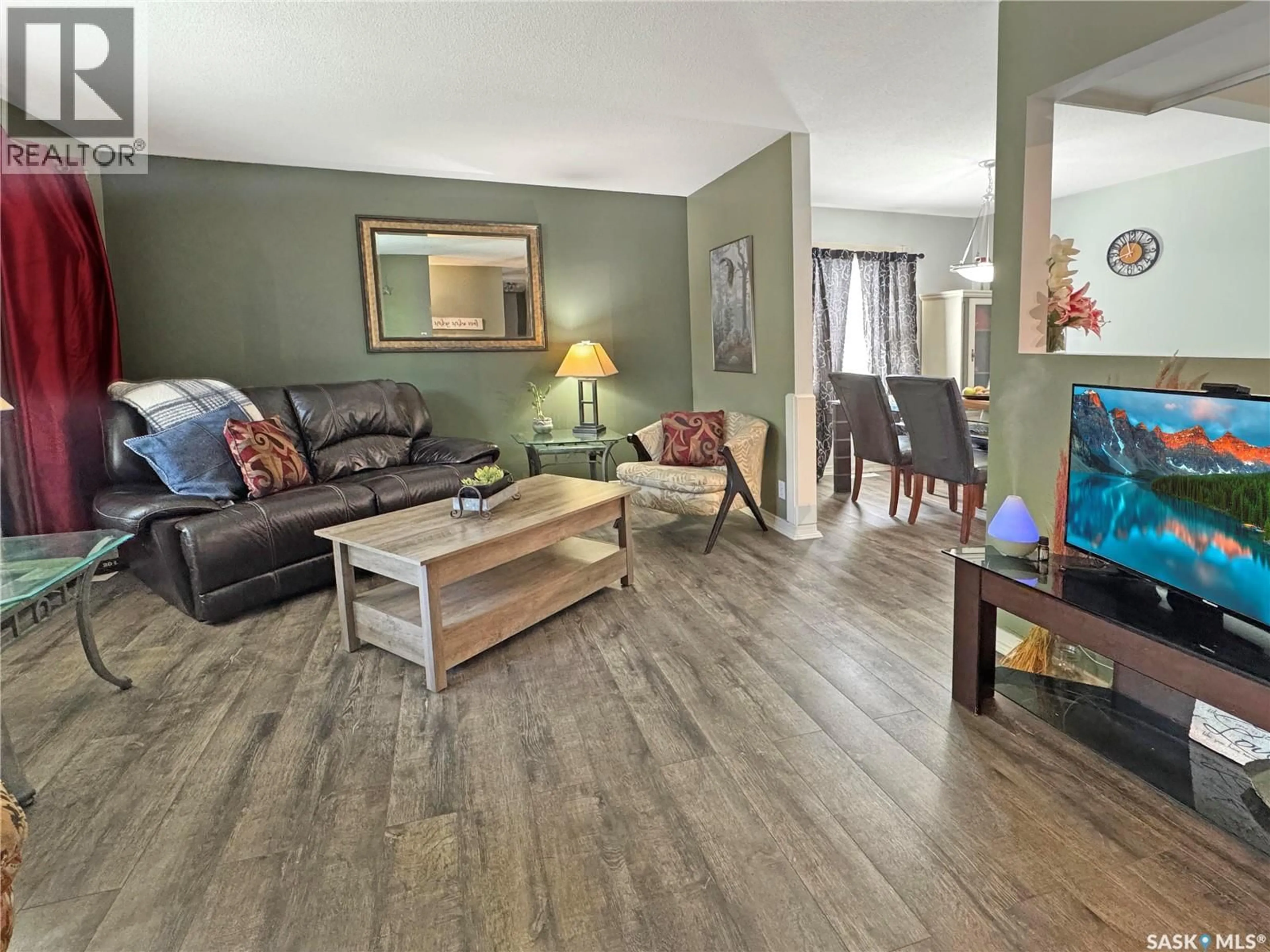 Living room with furniture, wood/laminate floor for 511 101ST STREET, North Battleford Saskatchewan S9A0Y5