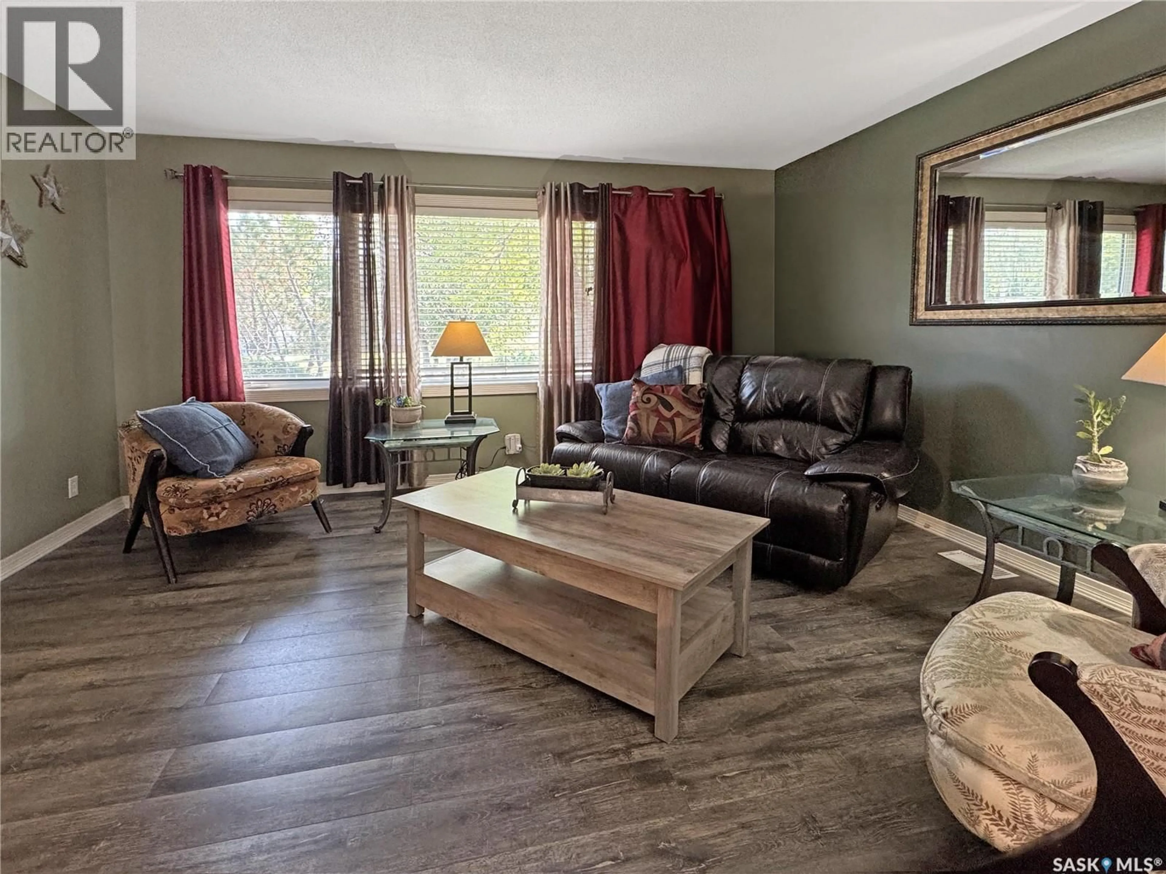 Living room with furniture, wood/laminate floor for 511 101ST STREET, North Battleford Saskatchewan S9A0Y5