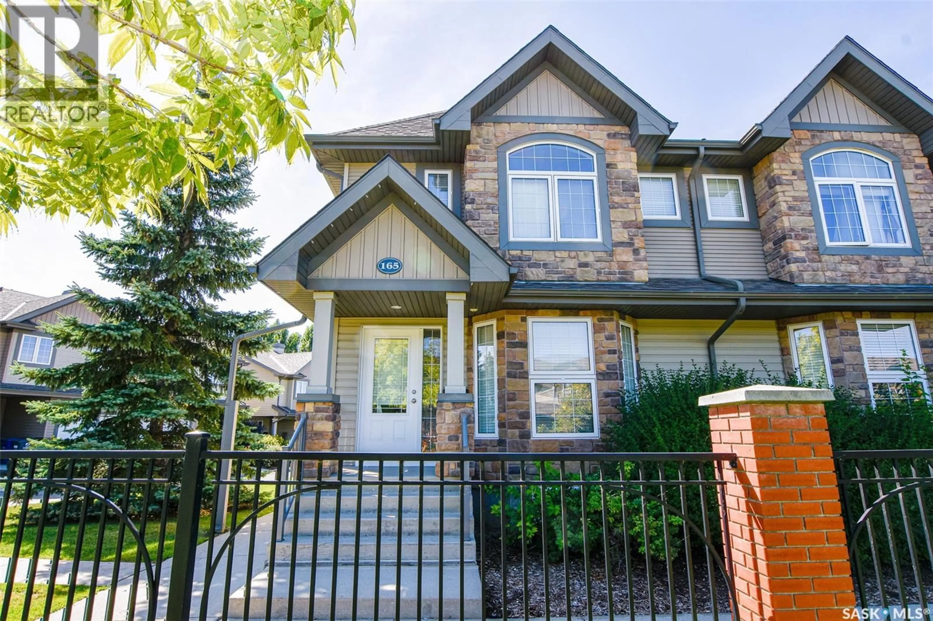 Home with brick exterior material, street for 165 STENSRUD ROAD, Saskatoon Saskatchewan S7W0A2