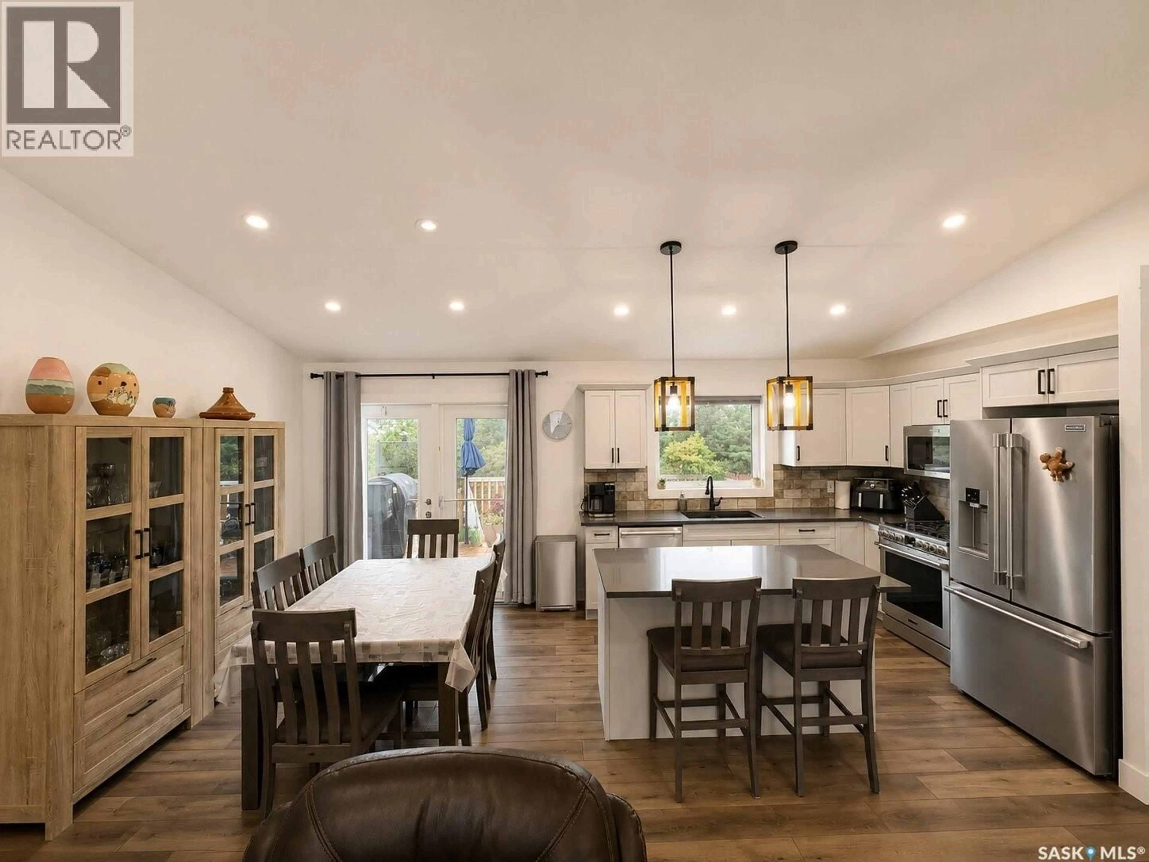 Open concept kitchen, wood/laminate floor for 218 KESTREL COURT, Rosthern Saskatchewan S0K3R0