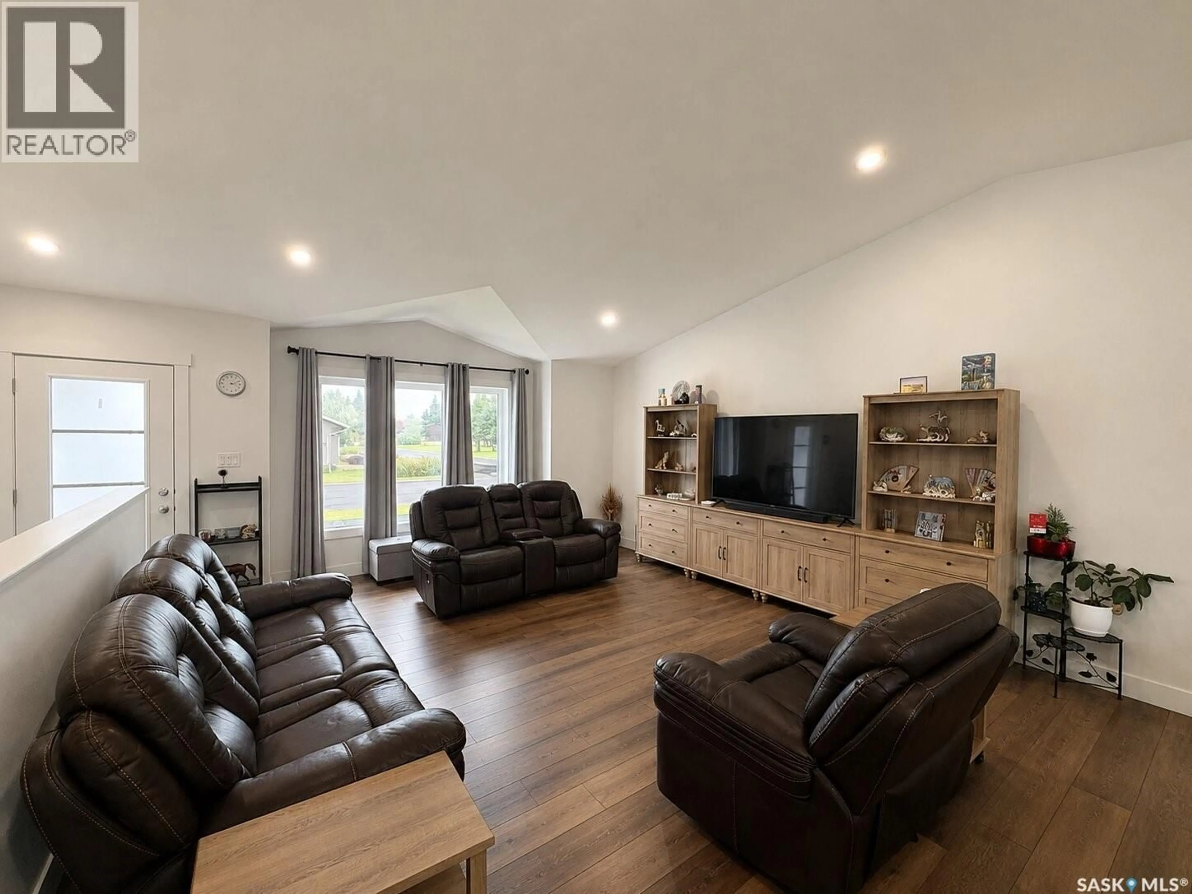 Living room with furniture, wood/laminate floor for 218 KESTREL COURT, Rosthern Saskatchewan S0K3R0