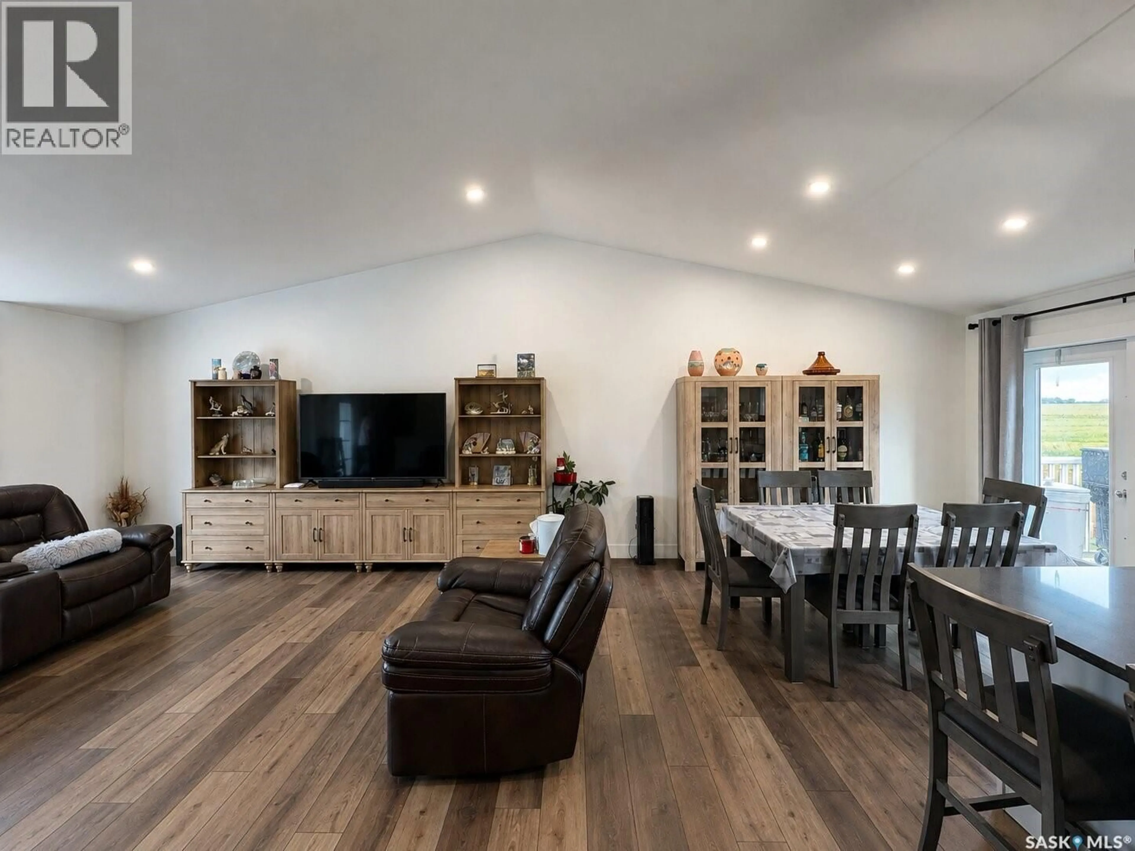 Living room with furniture, wood/laminate floor for 218 KESTREL COURT, Rosthern Saskatchewan S0K3R0