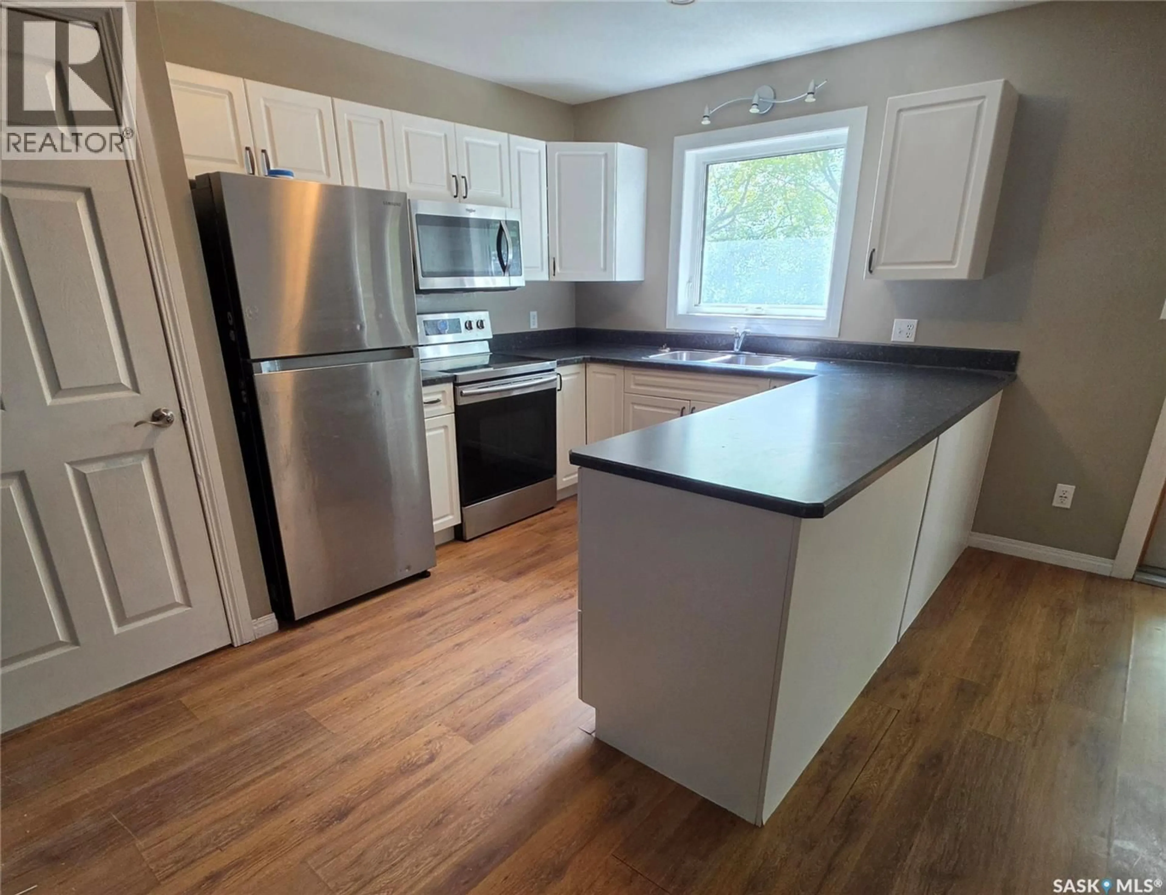 Open concept kitchen, wood/laminate floor for 327 1ST AVENUE, Preeceville Saskatchewan S0A3B0