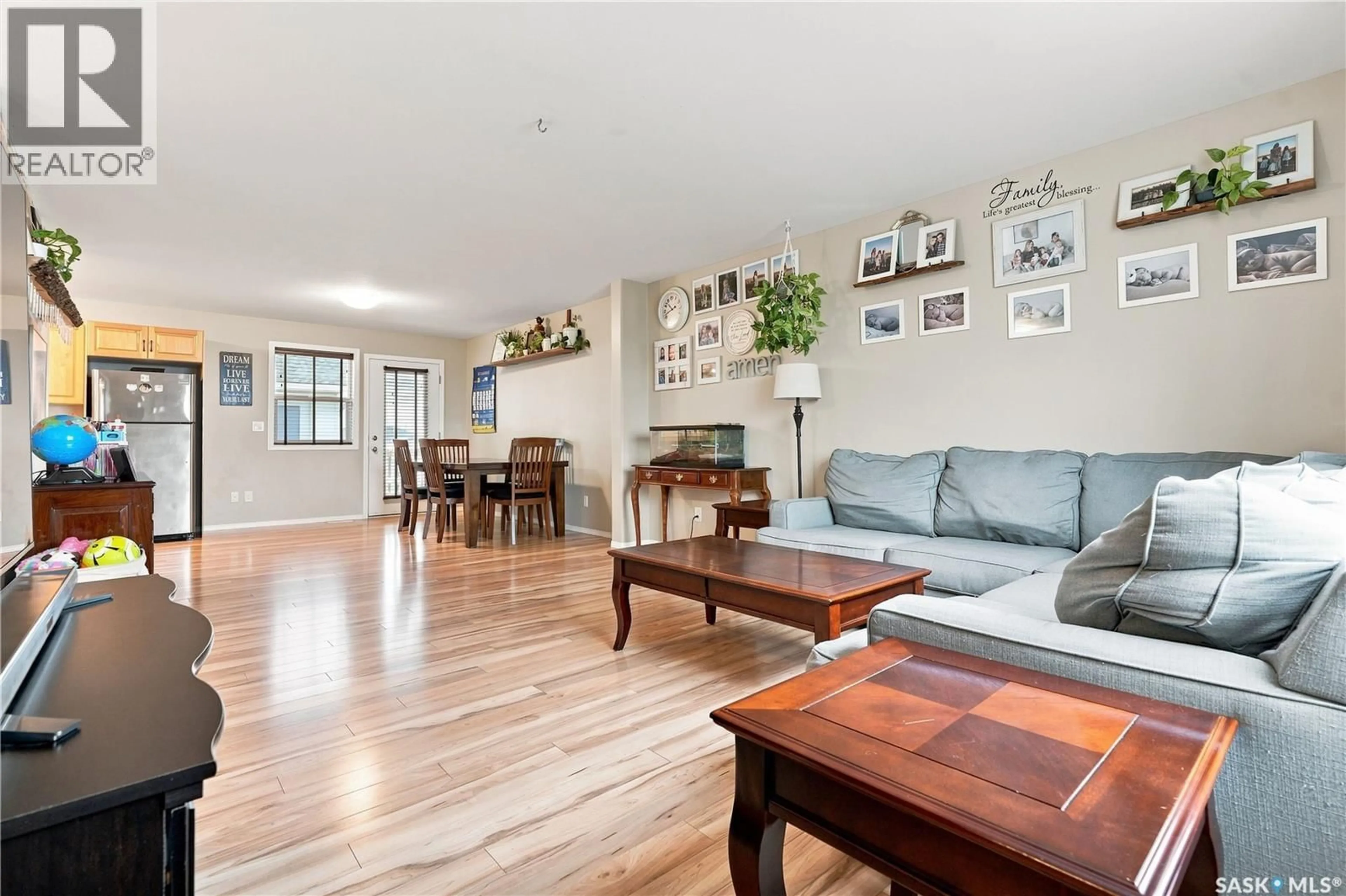 Living room with furniture, wood/laminate floor for 15 200 HIEBERT CRESCENT, Martensville Saskatchewan S0K2T2