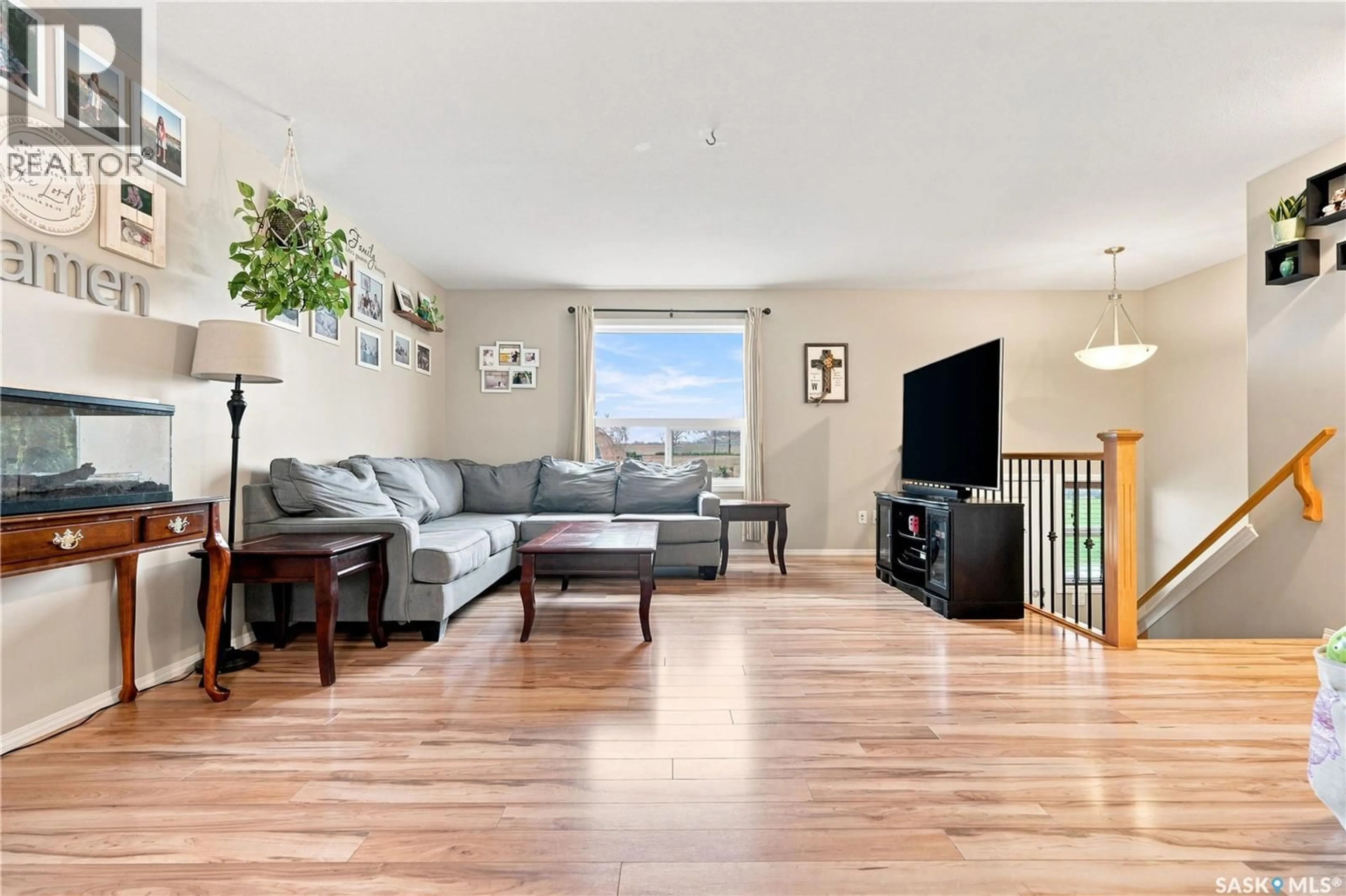 Living room with furniture, wood/laminate floor for 15 200 HIEBERT CRESCENT, Martensville Saskatchewan S0K2T2