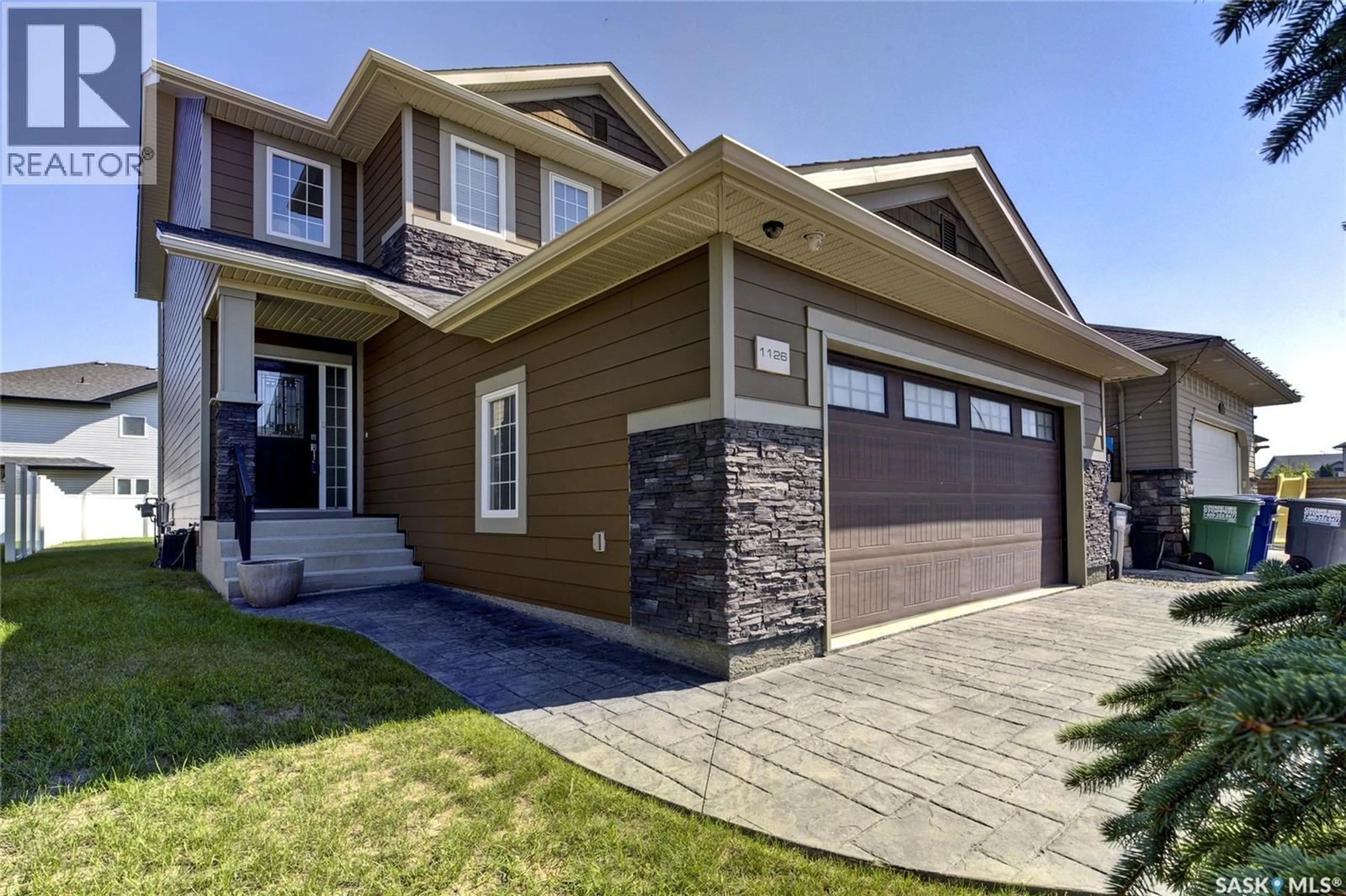 Home with brick exterior material, street for 1126 DENHAM RISE, Saskatoon Saskatchewan S7R0B2