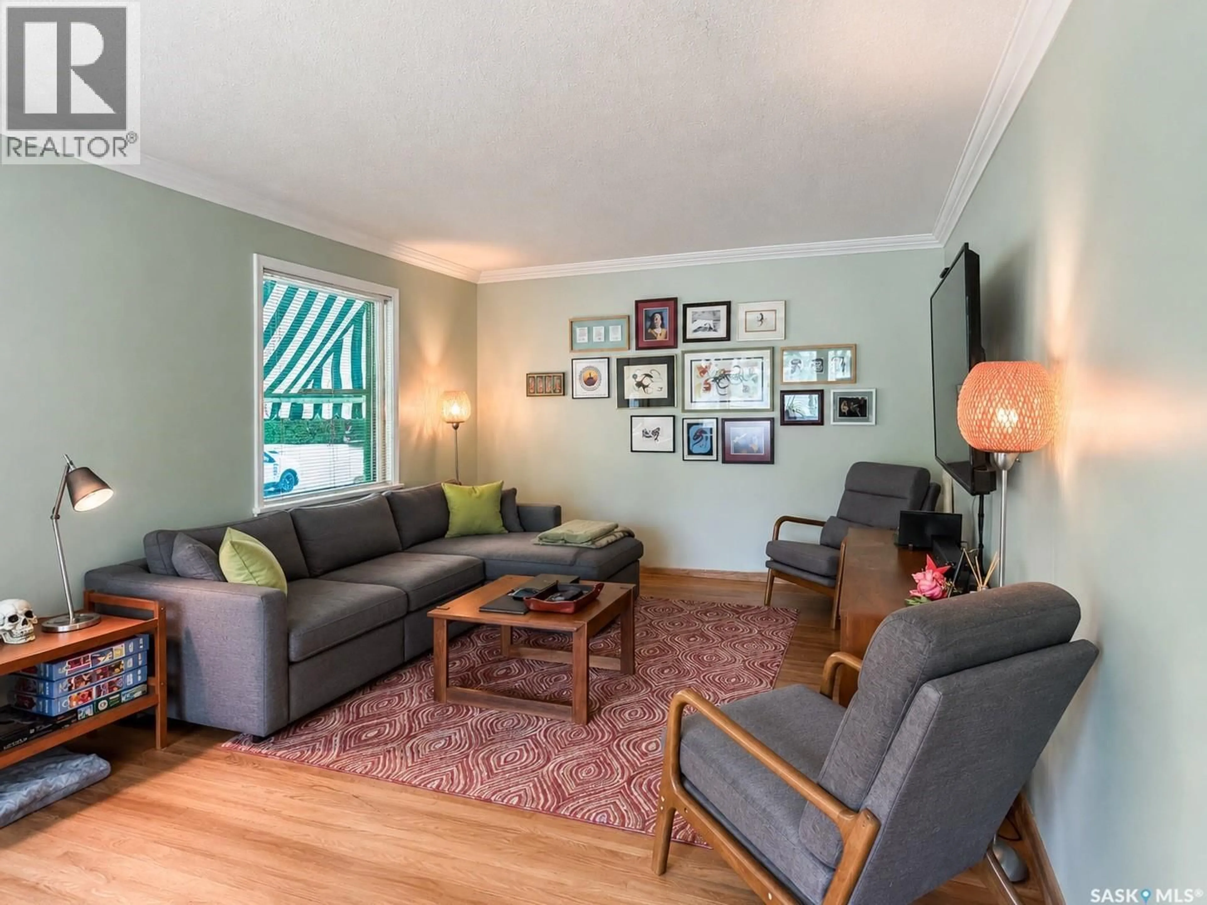 Living room with furniture, wood/laminate floor for 3037 ARGYLE ROAD, Regina Saskatchewan S4S2B3