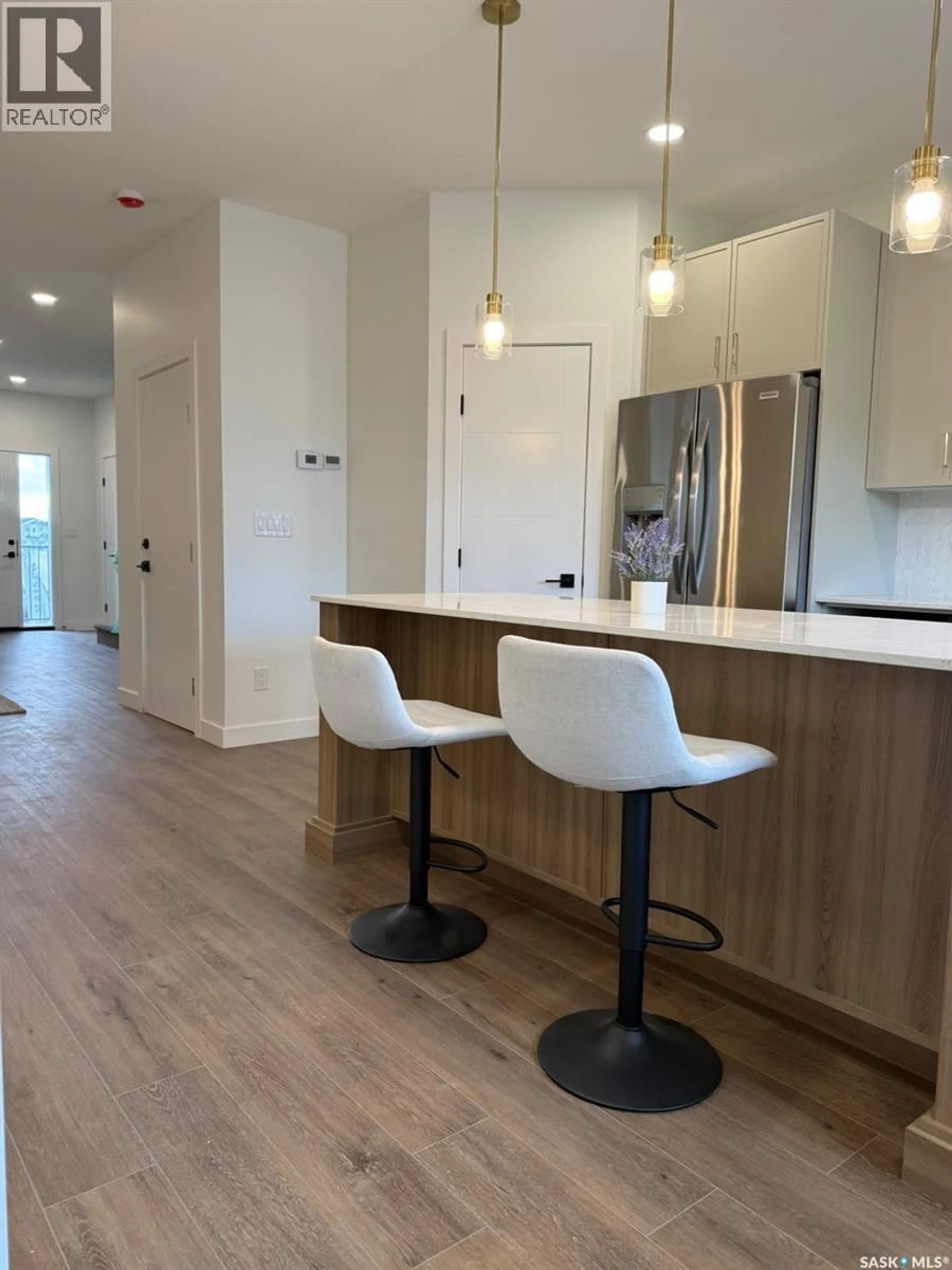 Open concept kitchen, wood/laminate floor for 225 ASPEN RIDGE STREET, Saskatoon Saskatchewan S7W1N1