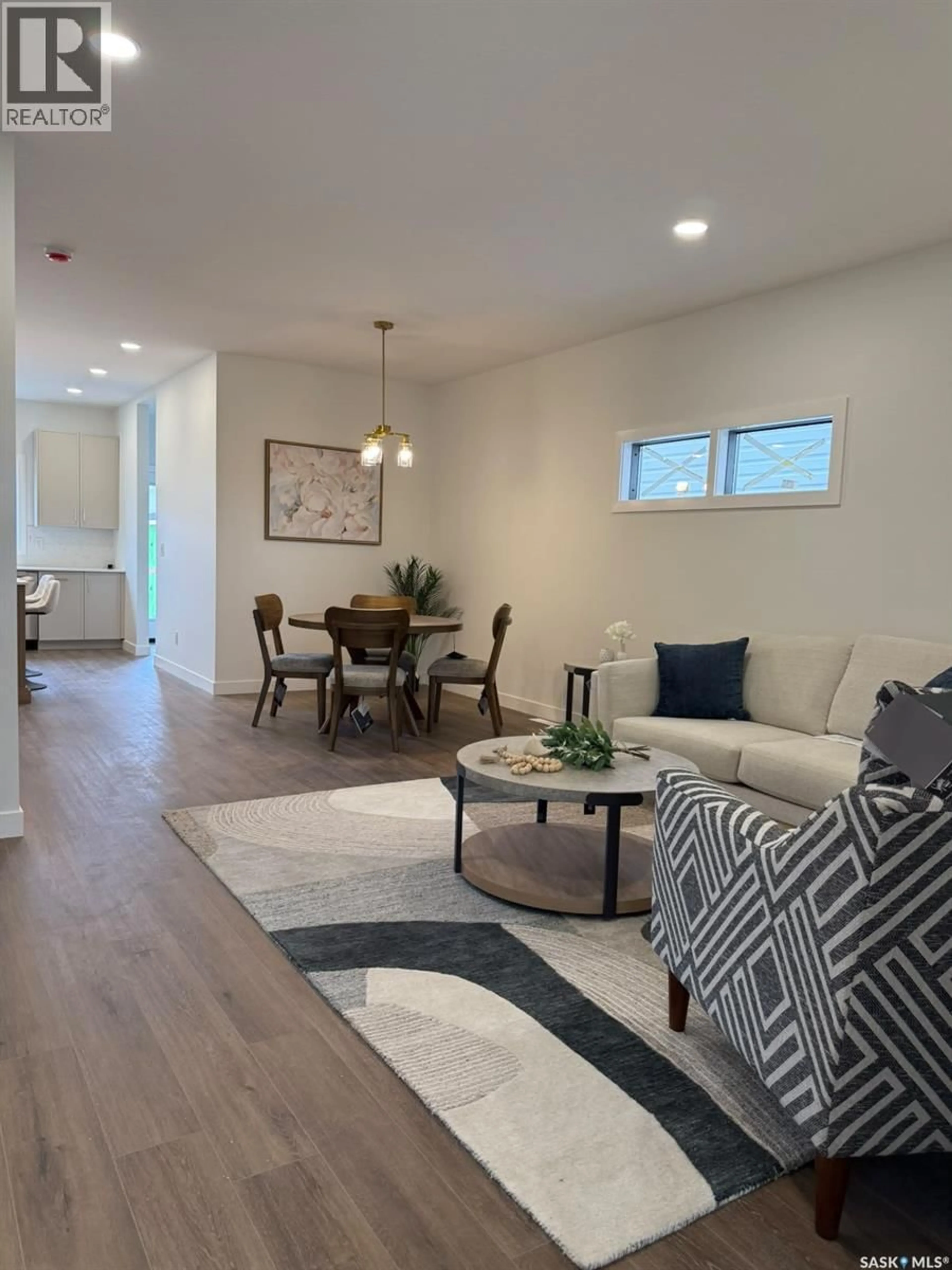 Living room with furniture, wood/laminate floor for 225 ASPEN RIDGE STREET, Saskatoon Saskatchewan S7W1N1