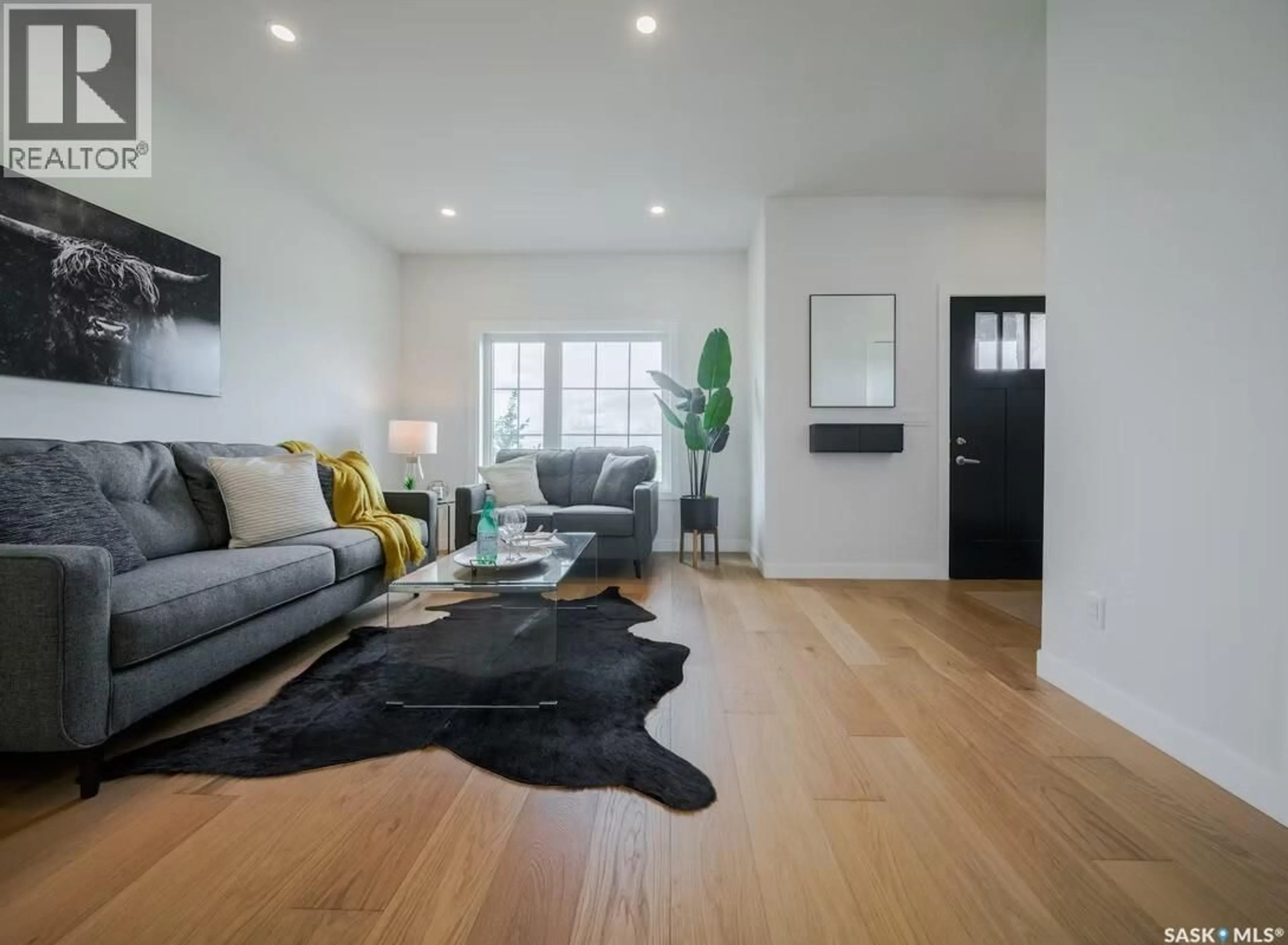 Living room with furniture, wood/laminate floor for 223 FEHEREGYHAZI BOULEVARD, Saskatoon Saskatchewan S7W0C2
