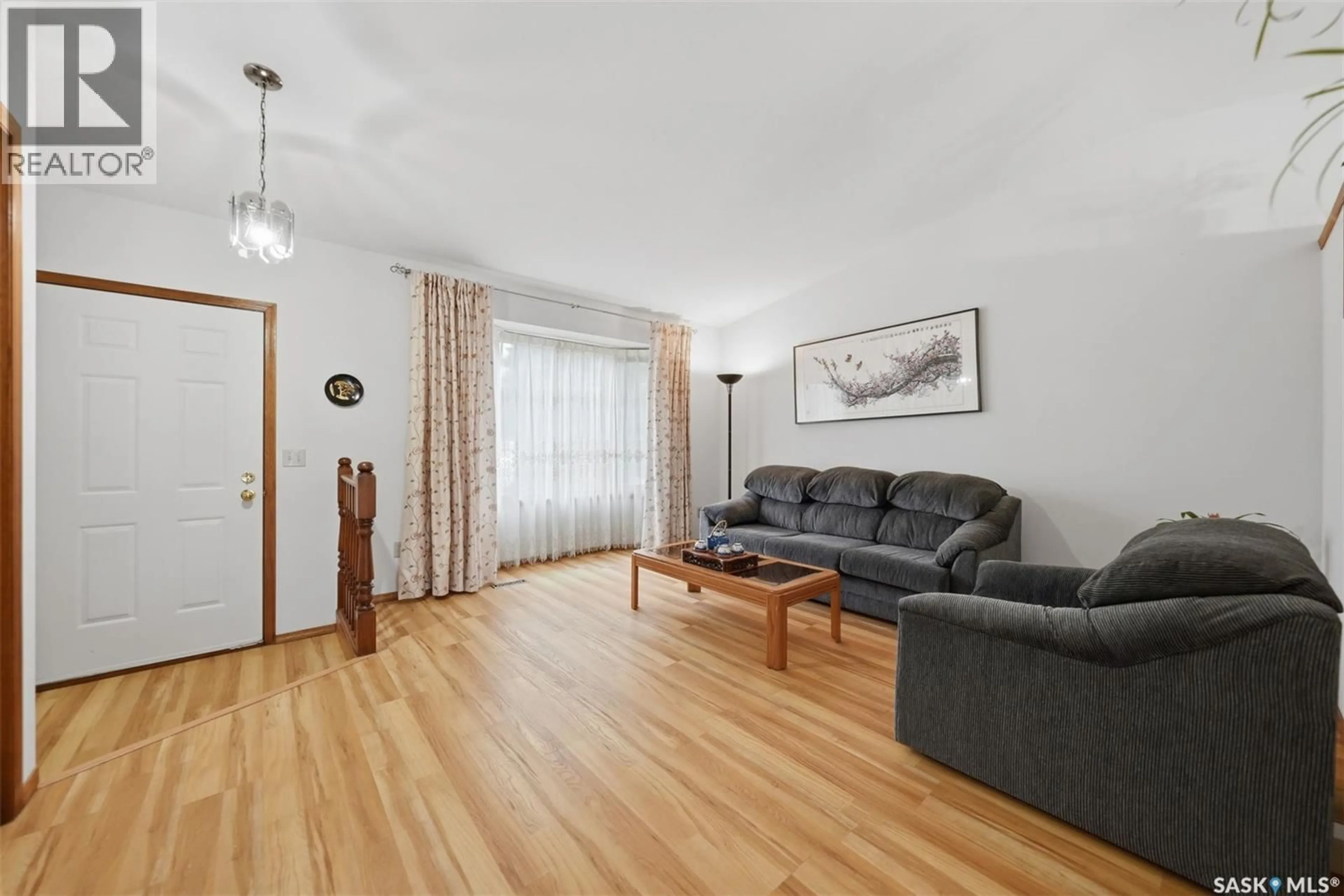 Living room with furniture, wood/laminate floor for 427 BRONSON CRESCENT, Saskatoon Saskatchewan S7J5E4