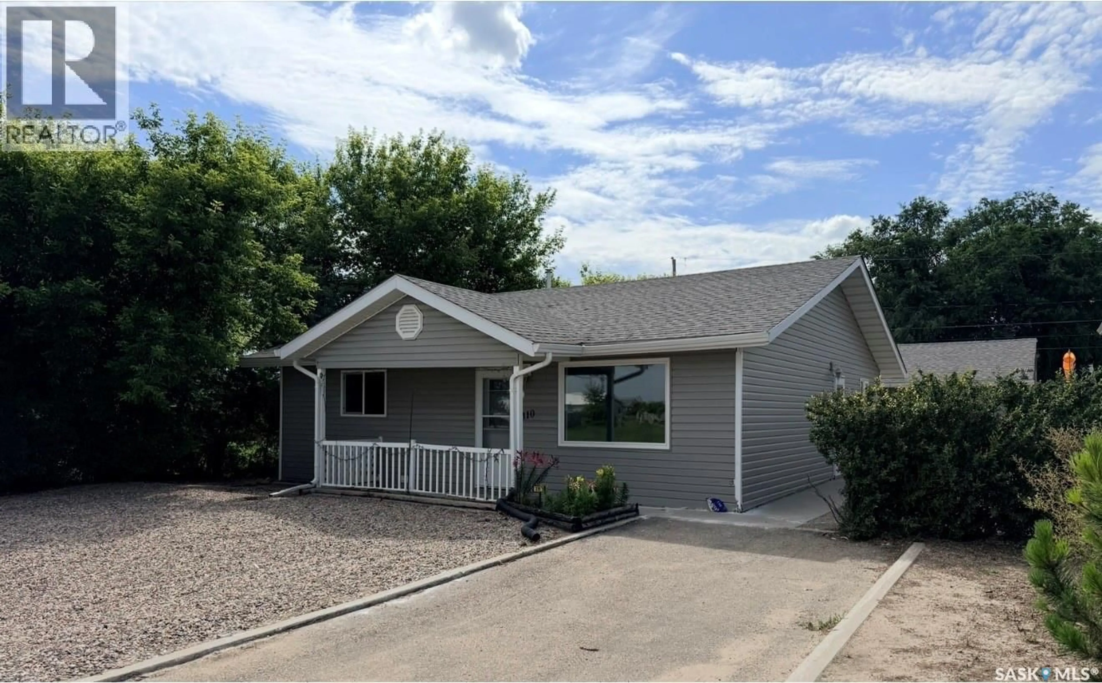Home with vinyl exterior material, street for 310 MCKENZIE STREET, Outlook Saskatchewan S0L2N0