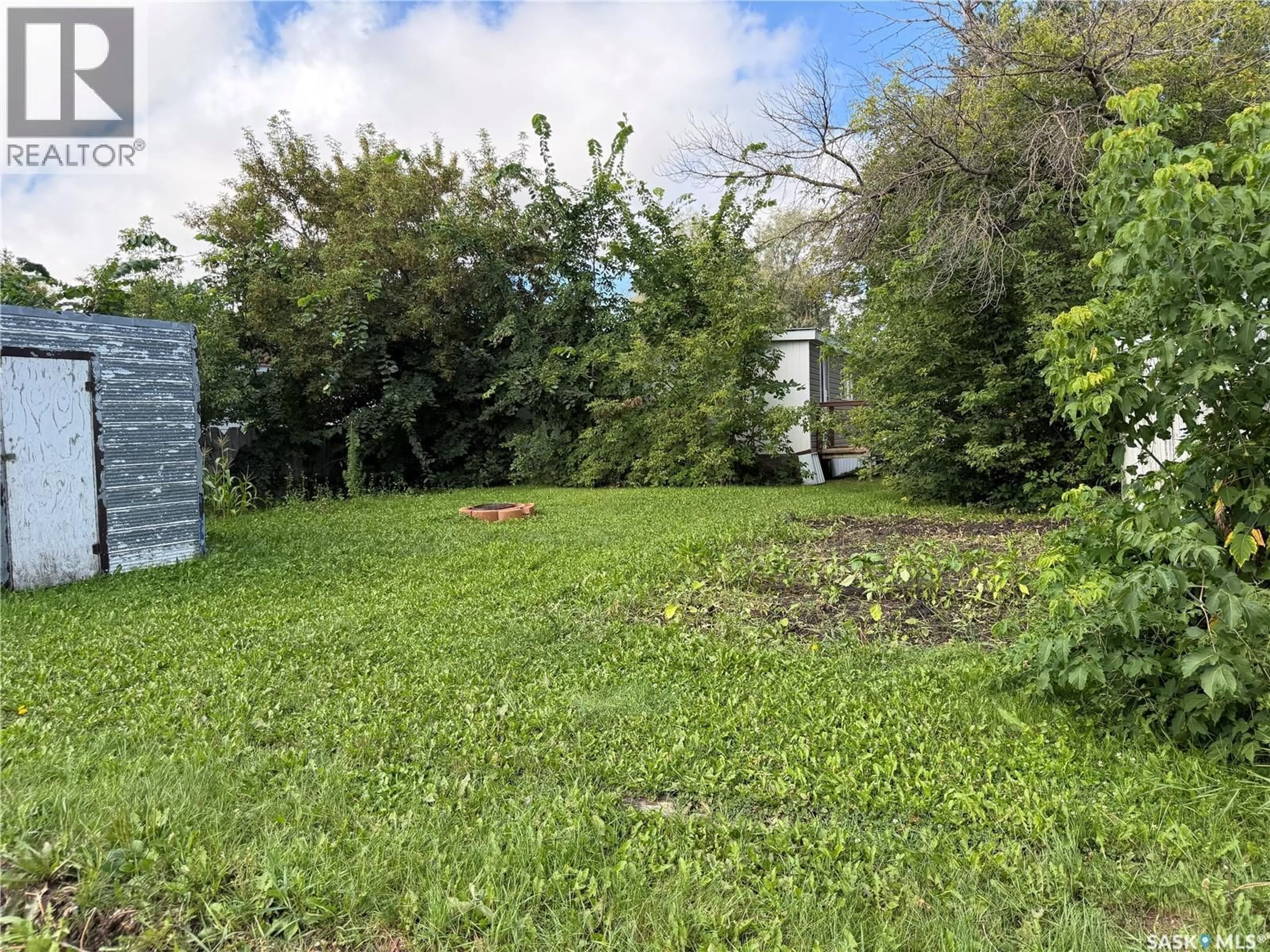 A pic from outside/outdoor area/front of a property/back of a property/a pic from drone, forest/trees view for 104 4TH AVENUE, Melfort Saskatchewan S0E1A0