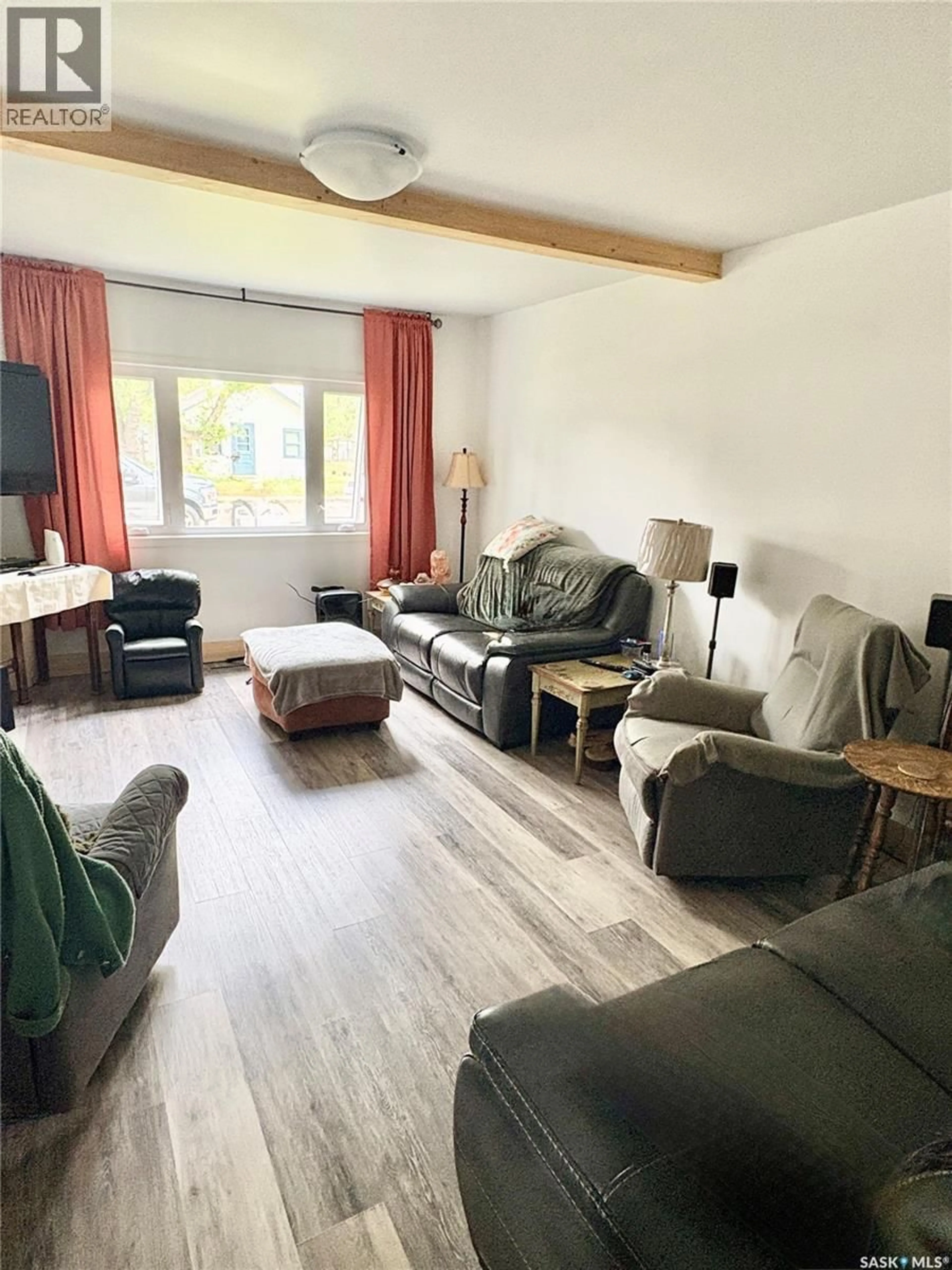 Living room with furniture, wood/laminate floor for 49 14TH AVENUE, Swift Current Saskatchewan S9H3S3