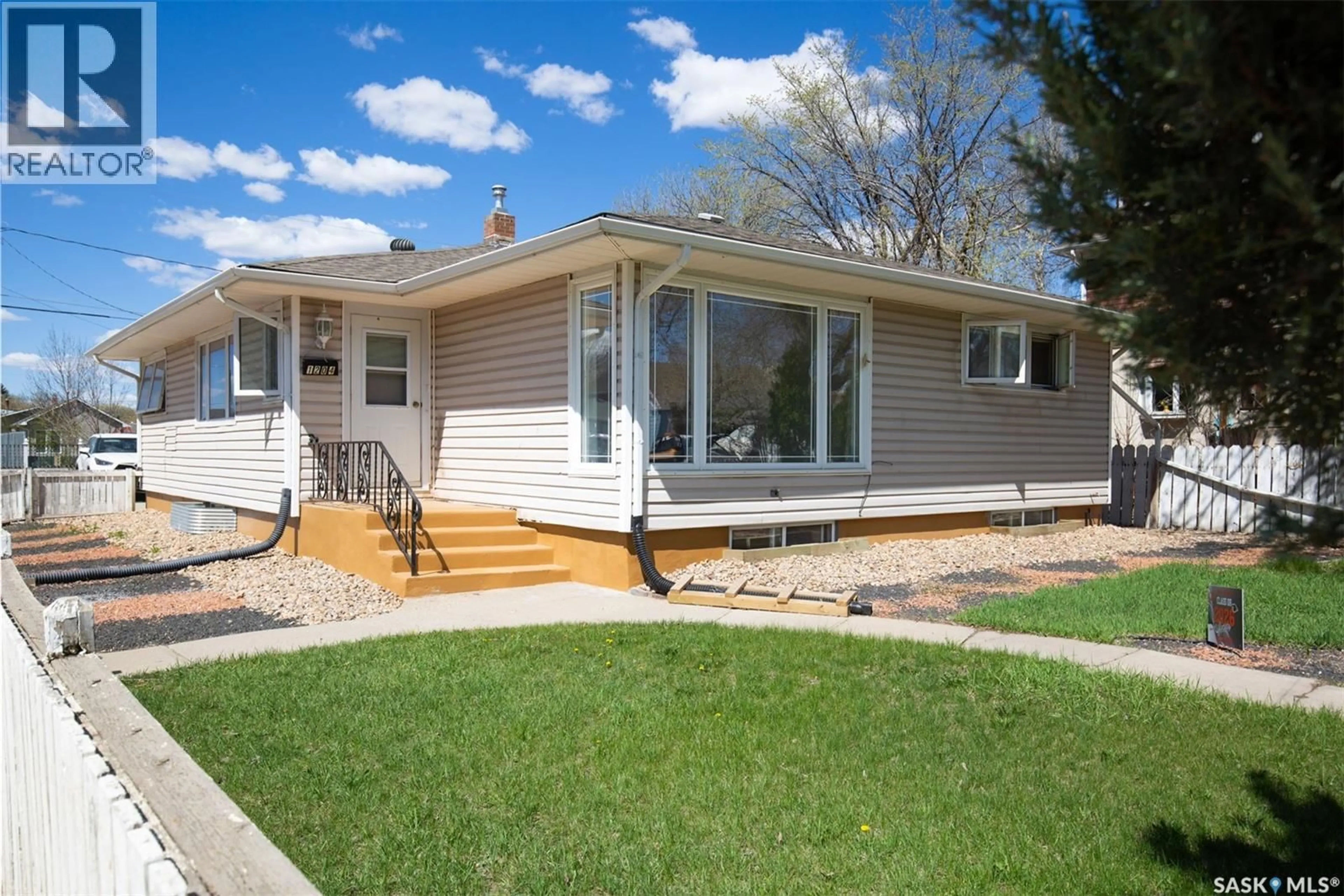 Home with vinyl exterior material, street for 1204 3RD AVENUE, Moose Jaw Saskatchewan S6H3V3