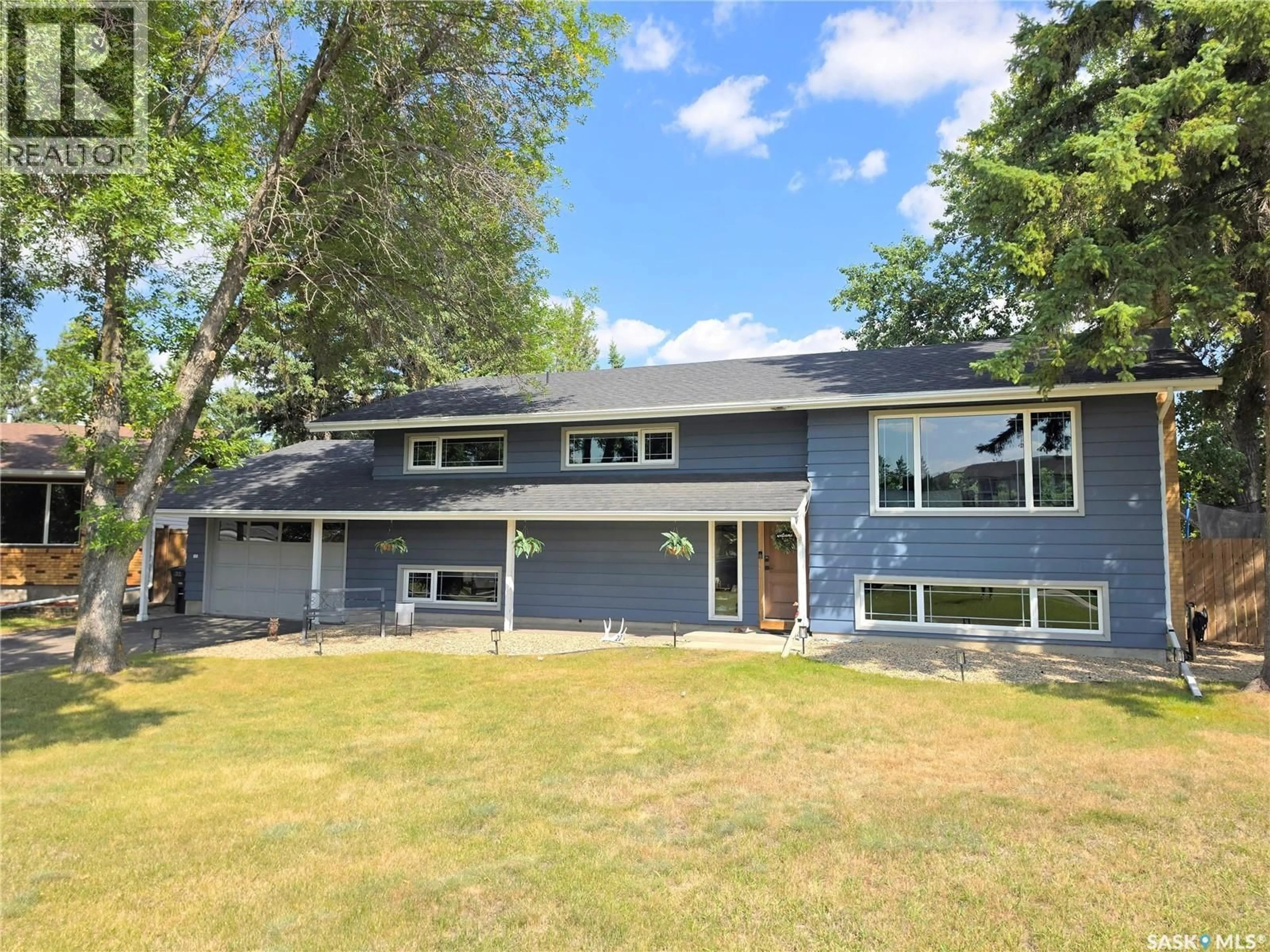 Home with vinyl exterior material, street for 22 CROCUS PLACE, Lanigan Saskatchewan S0K2M0