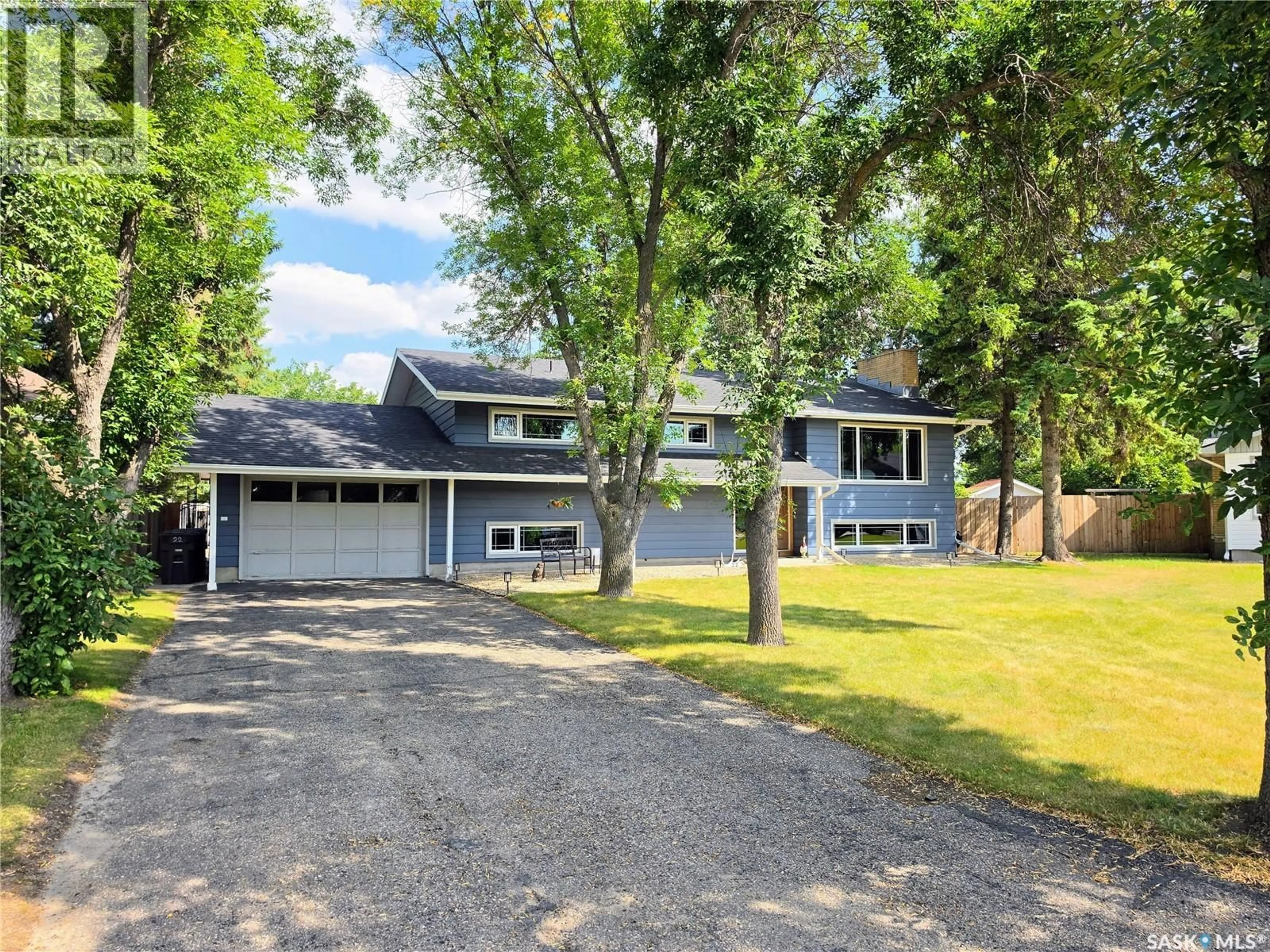 Home with vinyl exterior material, street for 22 CROCUS PLACE, Lanigan Saskatchewan S0K2M0