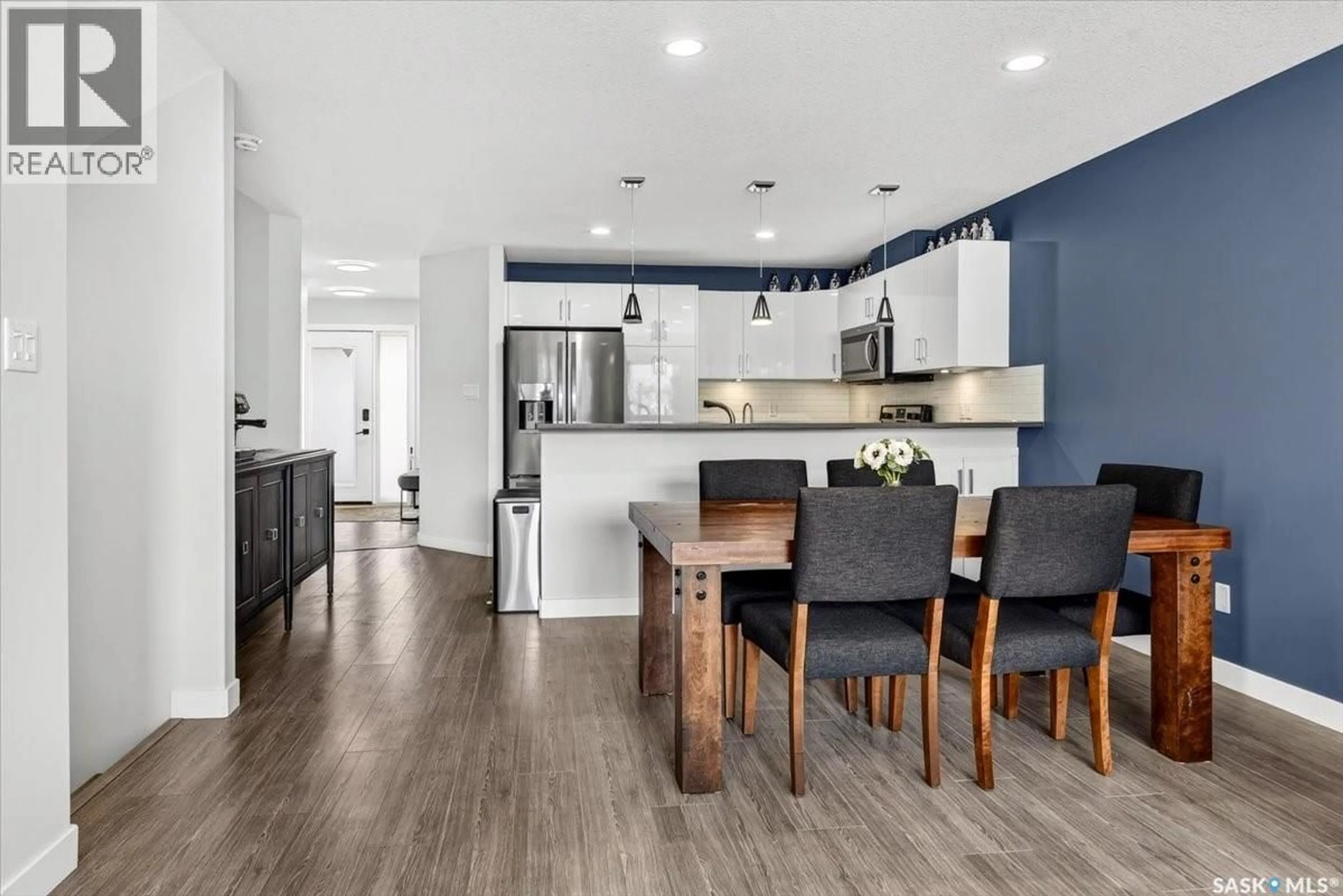 Open concept kitchen, wood/laminate floor for 104 - 3960 GREEN FALLS DRIVE, Regina Saskatchewan S4V3T5