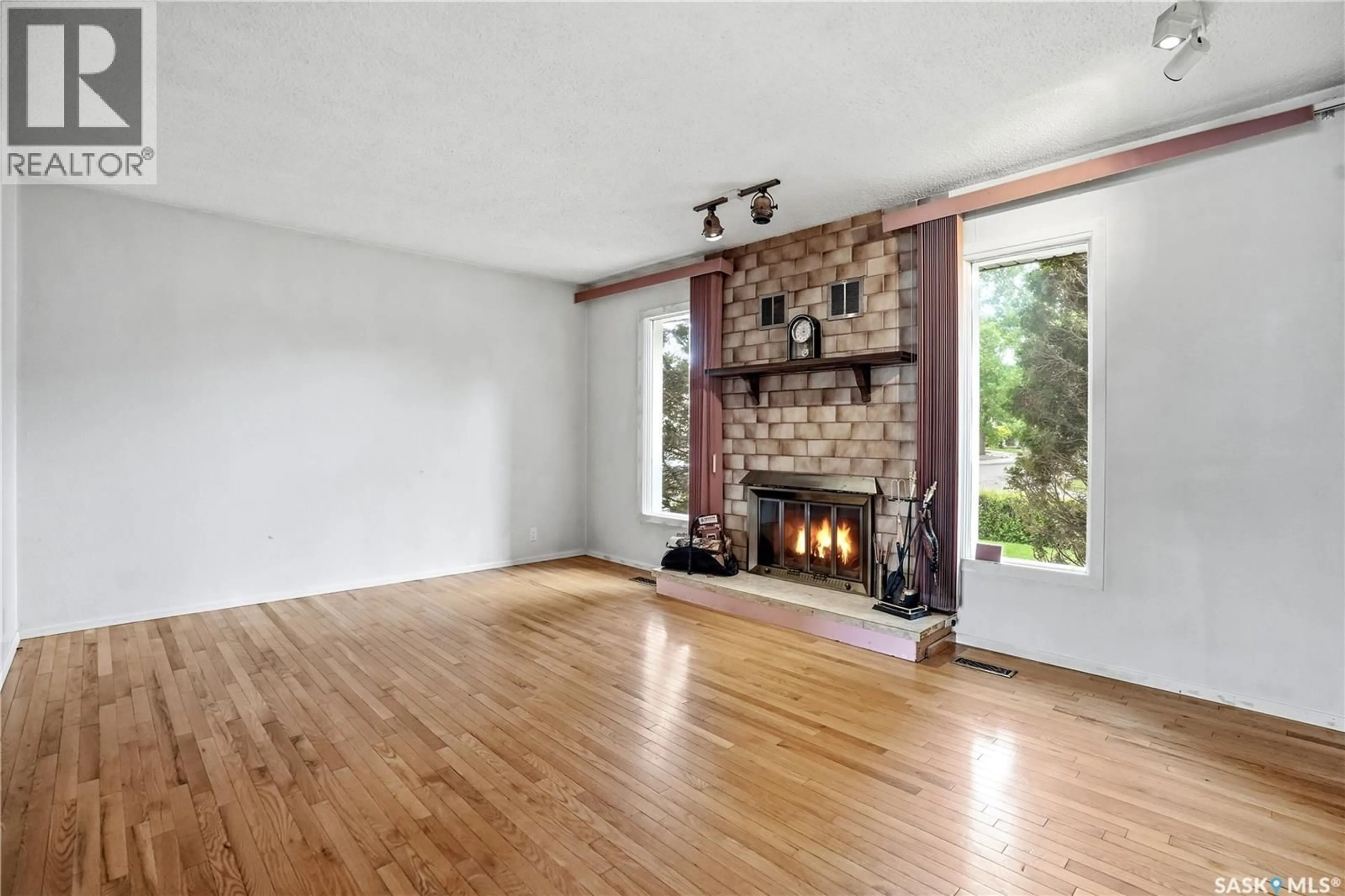 Living room with furniture, wood/laminate floor for 83 FUHRMANN CRESCENT, Regina Saskatchewan S4R5S4