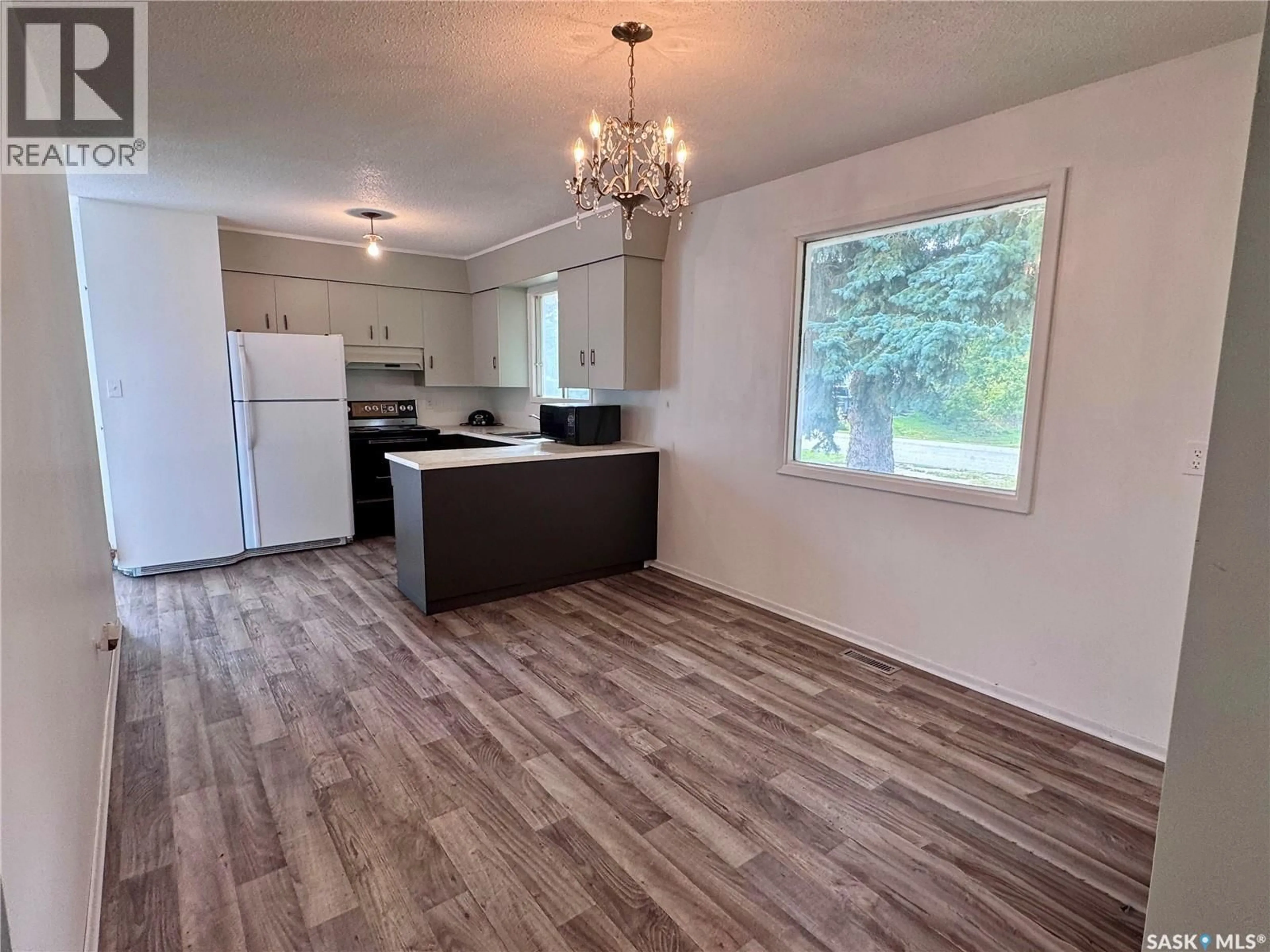 Open concept kitchen, wood/laminate floor for 917 GALT STREET, Whitewood Saskatchewan S0G5C0