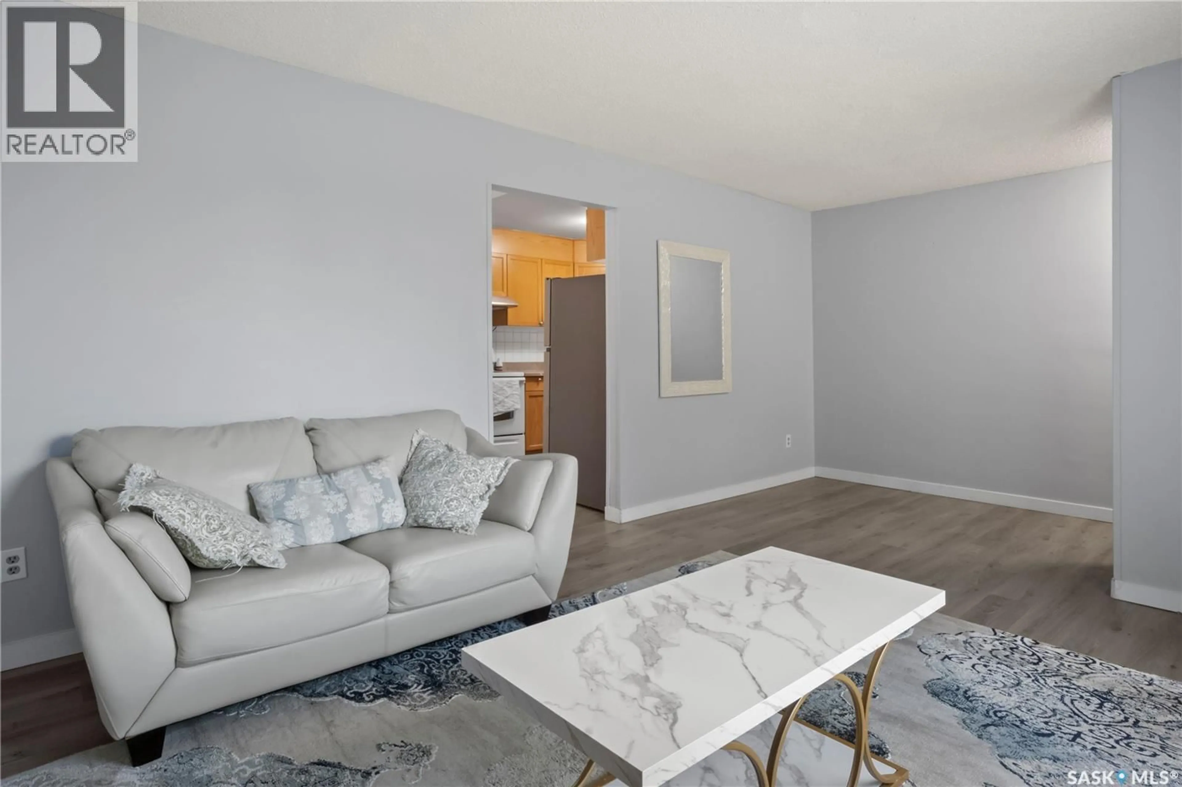 Living room with furniture, wood/laminate floor for 664 RETALLACK STREET, Regina Saskatchewan S4T2G4
