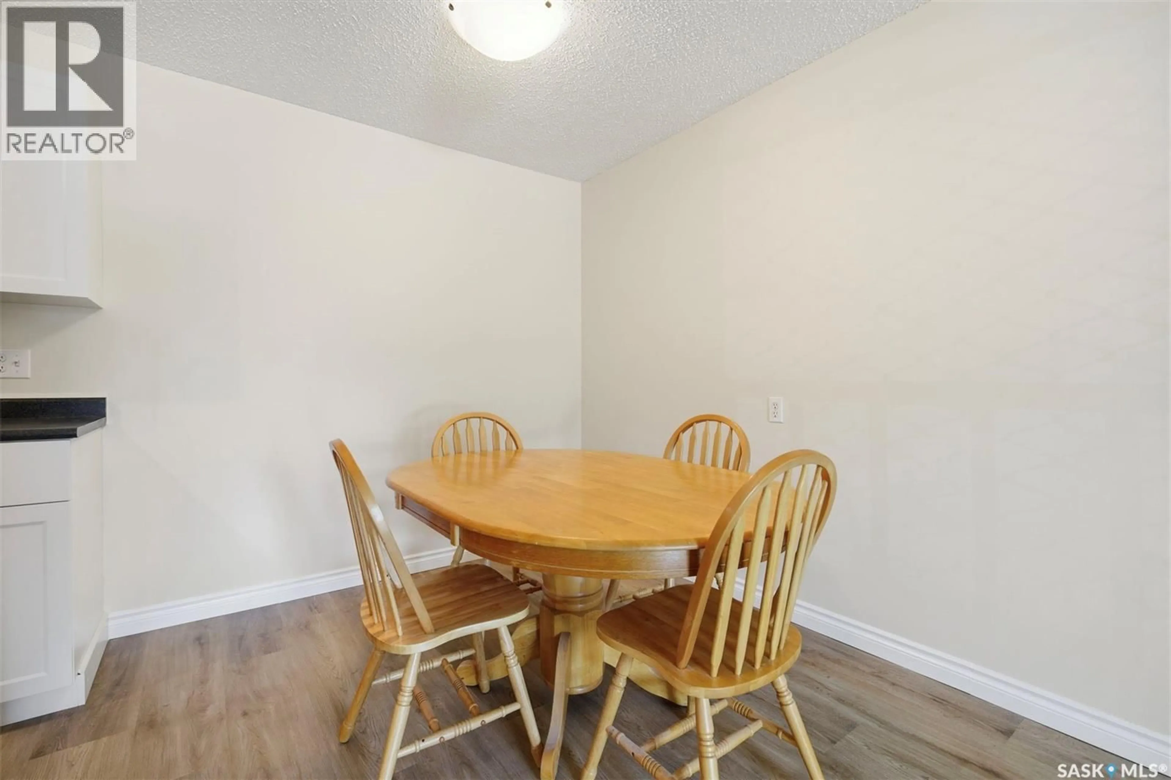 Dining room, wood/laminate floor for 105A 4040 8TH STREET, Saskatoon Saskatchewan S7H5L4
